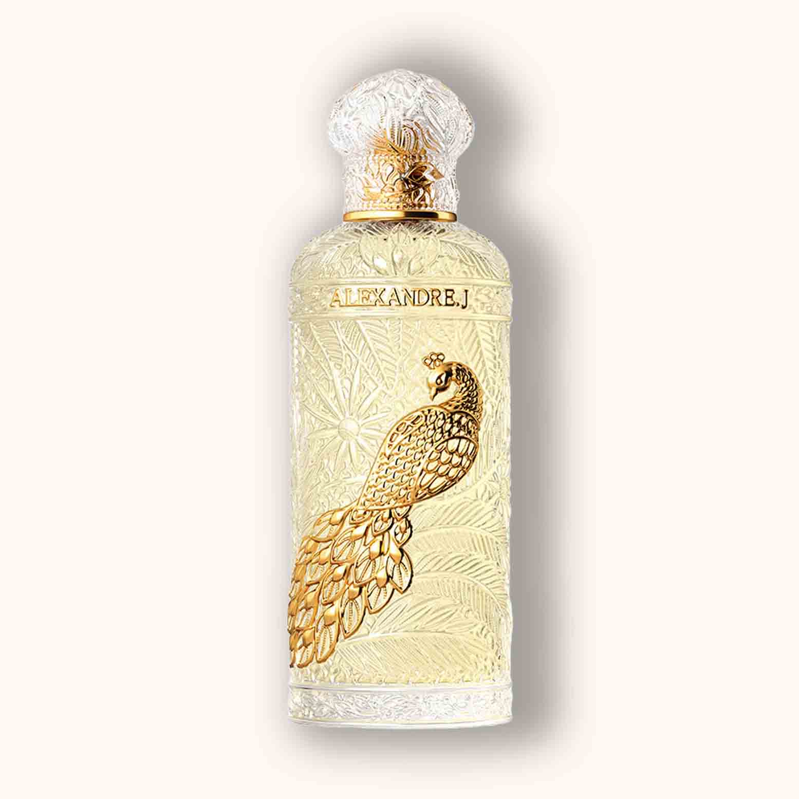 Alt text: A luxurious fragrance bottle of Alexandre.J Gold Imperial Peacock, featuring intricate gold peacock detailing and an ornate cap, set against a soft cream background.