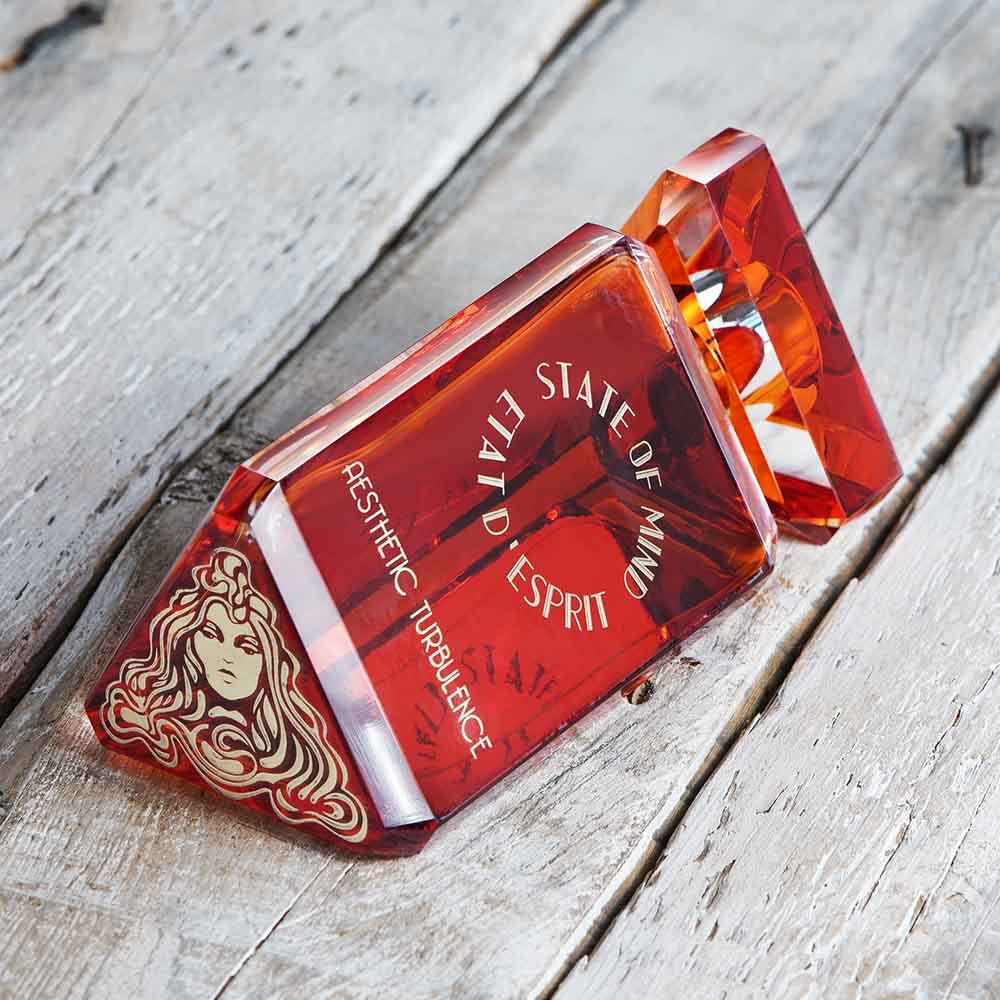 Promo photo of the bottom of a State of Mind Aesthatic Turbulence Perfume bottle