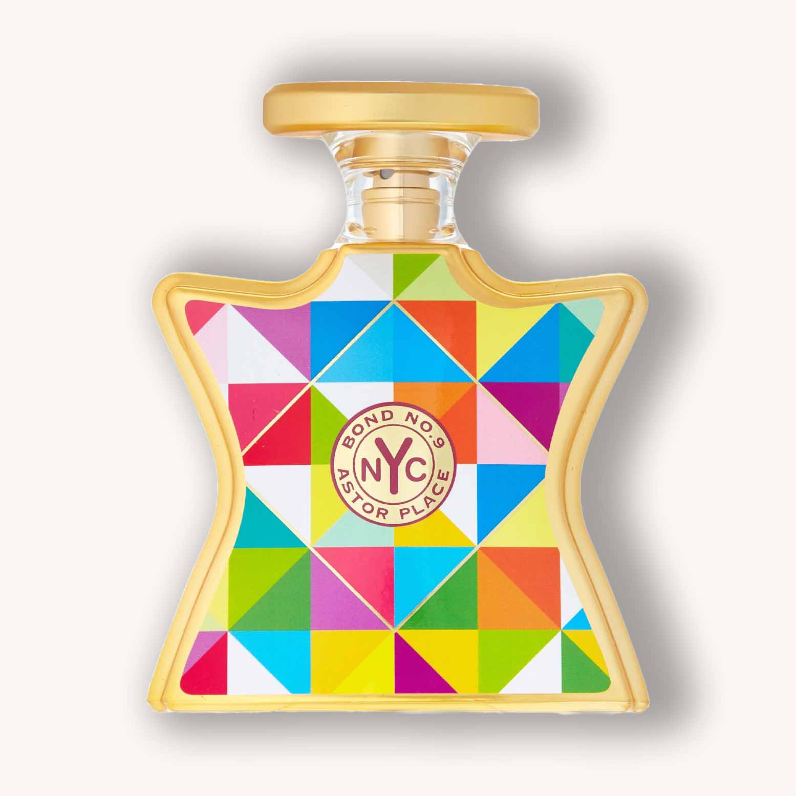 A colorful, geometric-patterned perfume bottle of Bond No. 9 Astor Place, featuring a unique star shape and a gold cap. The vibrant design incorporates bright triangles and a central logo.