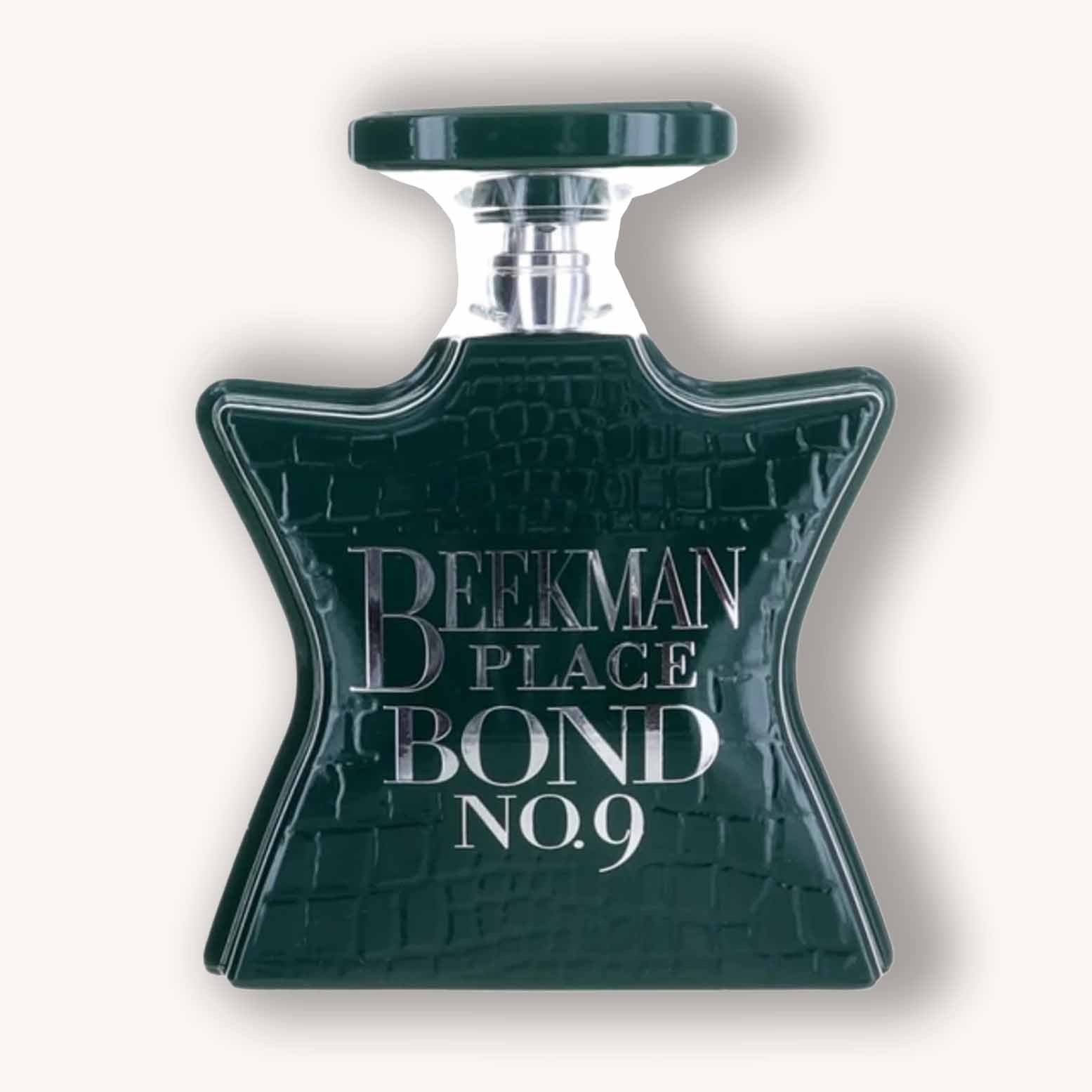 Alt text: "Bond No.9 Beekman Place fragrance bottle featuring a distinctive star-shaped design with a dark green finish and engraved silver label."