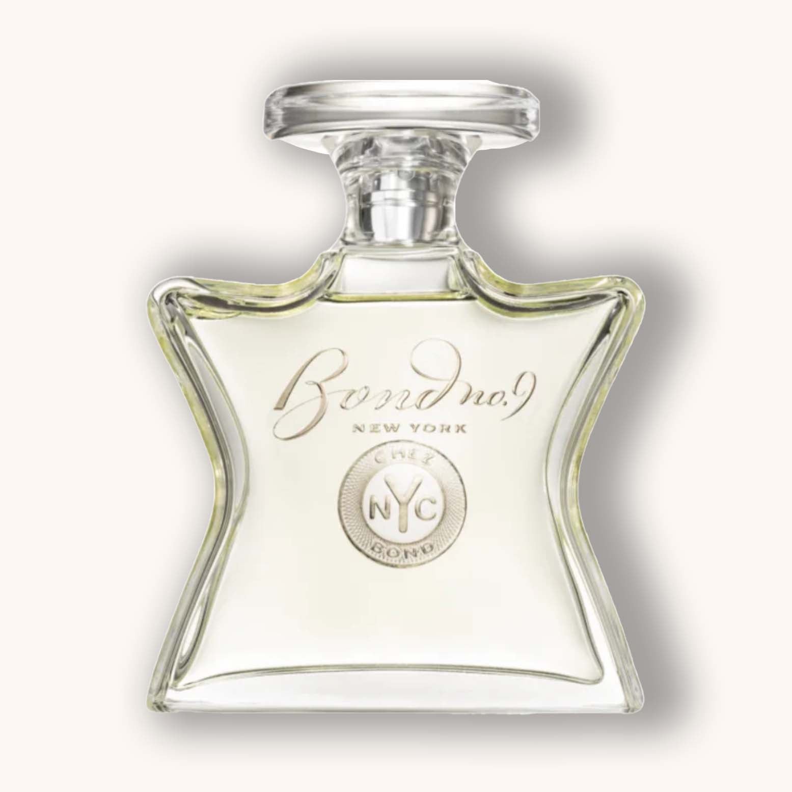 Alt text: A clear, star-shaped glass bottle of Bond No. 9 Chez Bond perfume, featuring the brand's logo and a silver accent. The light yellow fragrance inside is visible against a neutral background.