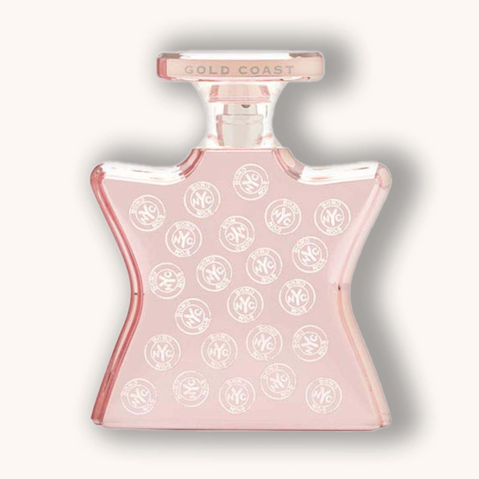 Alt text: A stylish bottle of Bond No. 9 Gold Coast perfume, featuring a unique star-shaped design and a soft pink hue adorned with white circular logos. The cap is labeled "GOLD COAST," highlighting the fragrance's luxurious appeal.