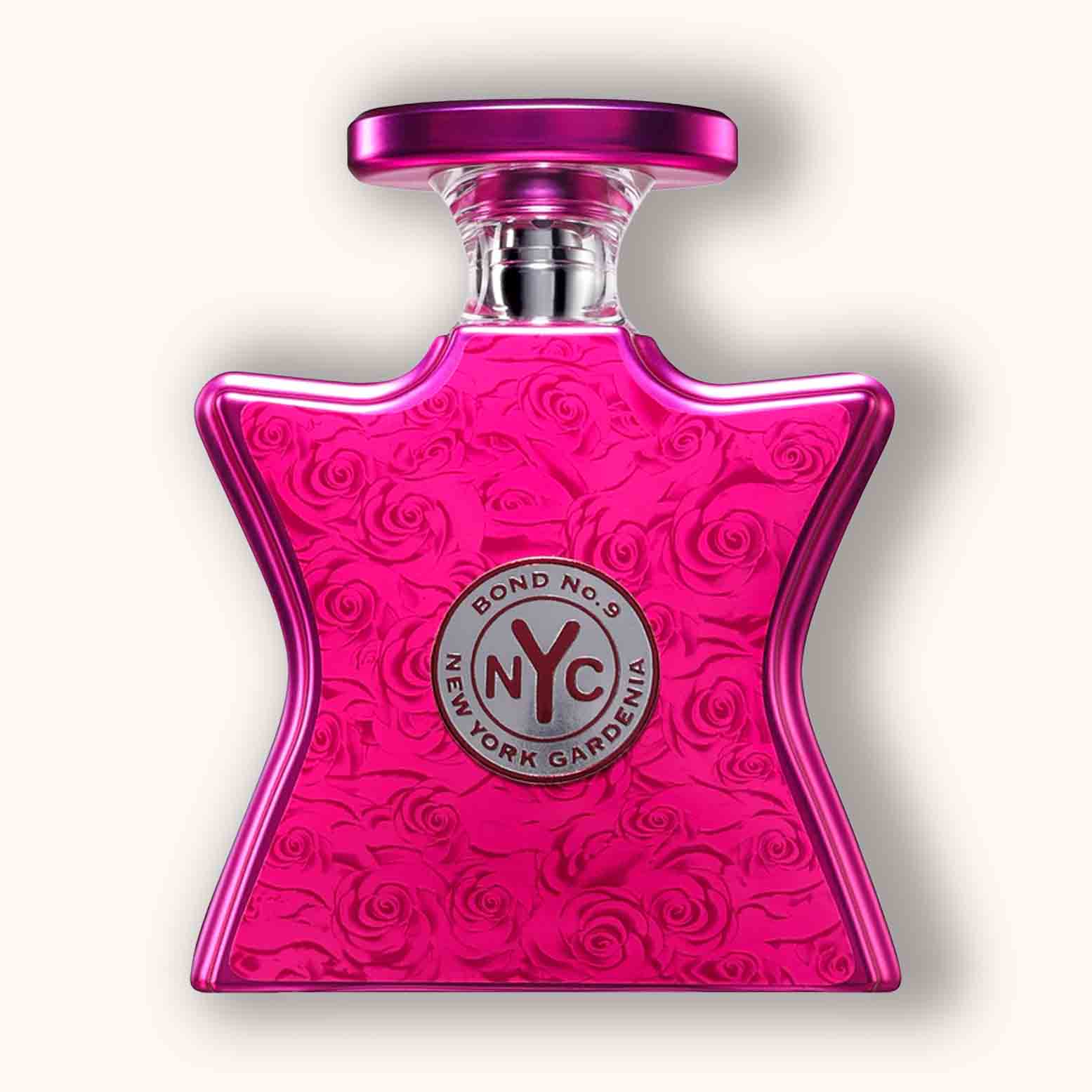 Alt text: A vibrant, star-shaped bottle of Bond No. 9 New York Gardenia perfume, featuring a textured floral design in bright pink and adorned with a silver logo.