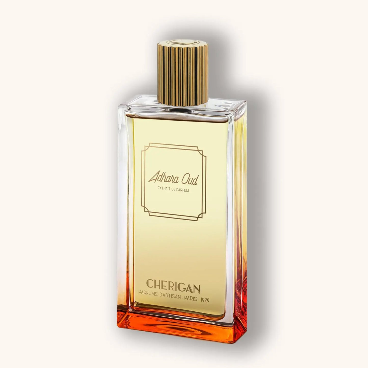 Alt tag: A sleek glass bottle of Cherigan Adhara Oud perfume, featuring a golden cap and a gradient of amber and yellow liquid inside, elegantly displayed against a soft beige background.