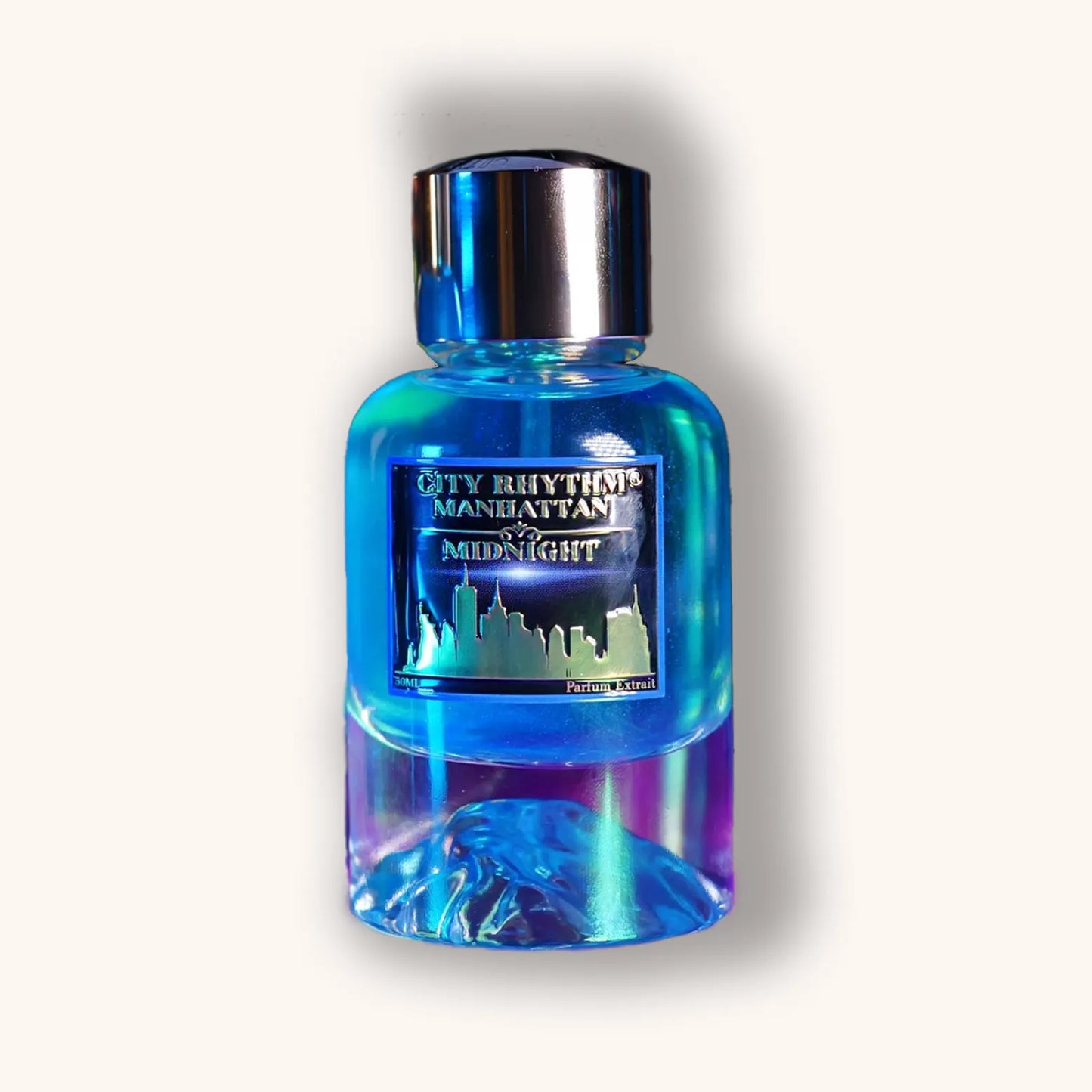 Alt tag: A sleek, modern bottle of 'City Rhythm Manhattan Midnight,' featuring a vibrant blue liquid and an artistic base that transitions from blue to purple. The bottle has a metallic silver cap and an elegant city skyline label.
