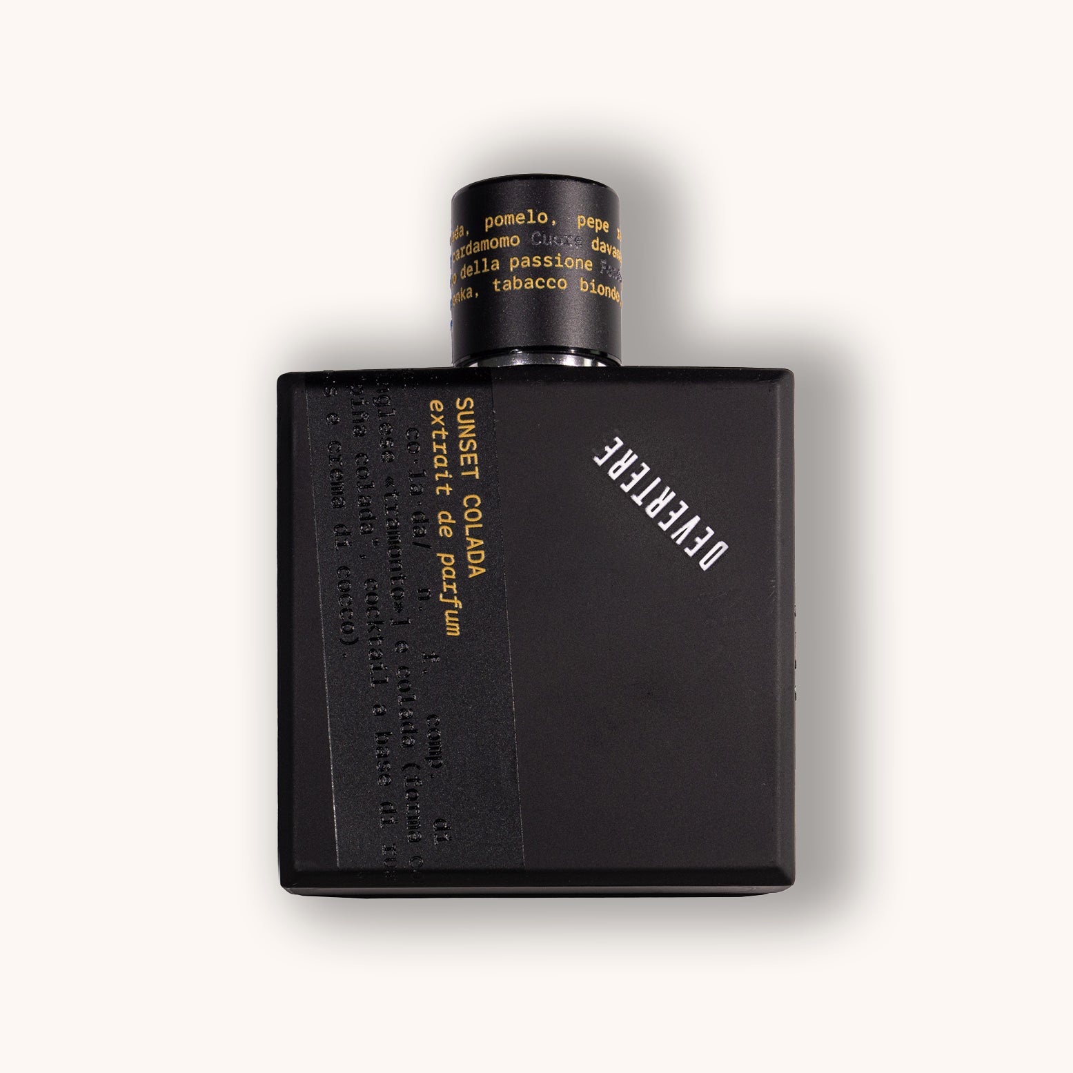 Black perfume bottle of Devertere Sunset Colada with yellow text on a white background