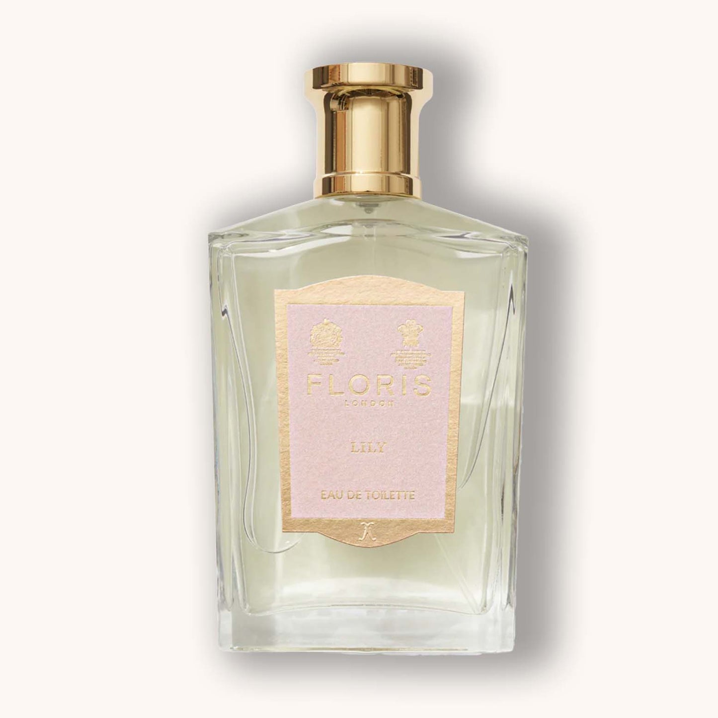 A clear glass bottle of Floris London Lily Eau de Toilette featuring a gold and pink label. The elegant design reflects a fresh, floral fragrance perfect for any occasion.