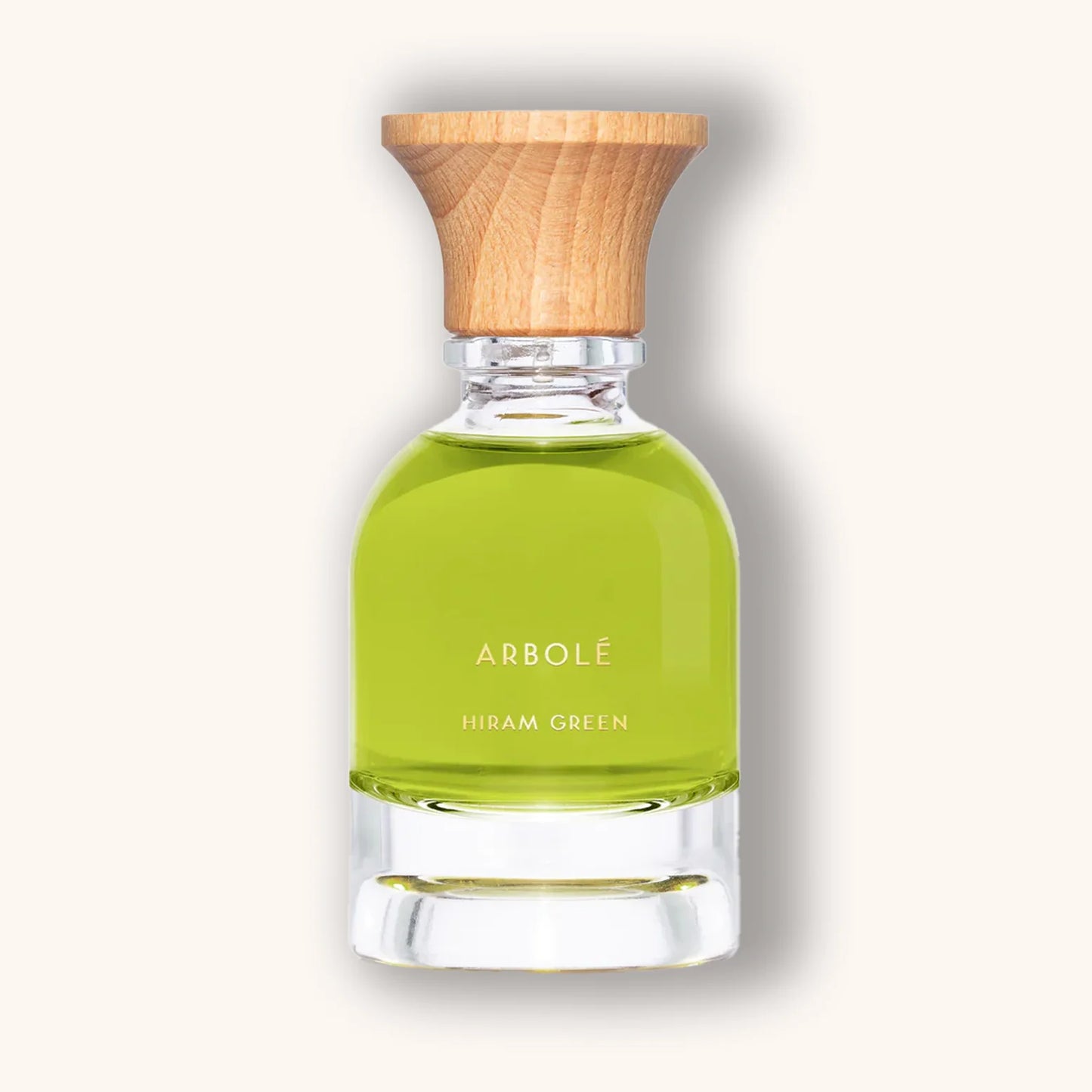 Hiram Green Arbolé natural perfume bottle with green liquid and wooden cap on a neutral background.