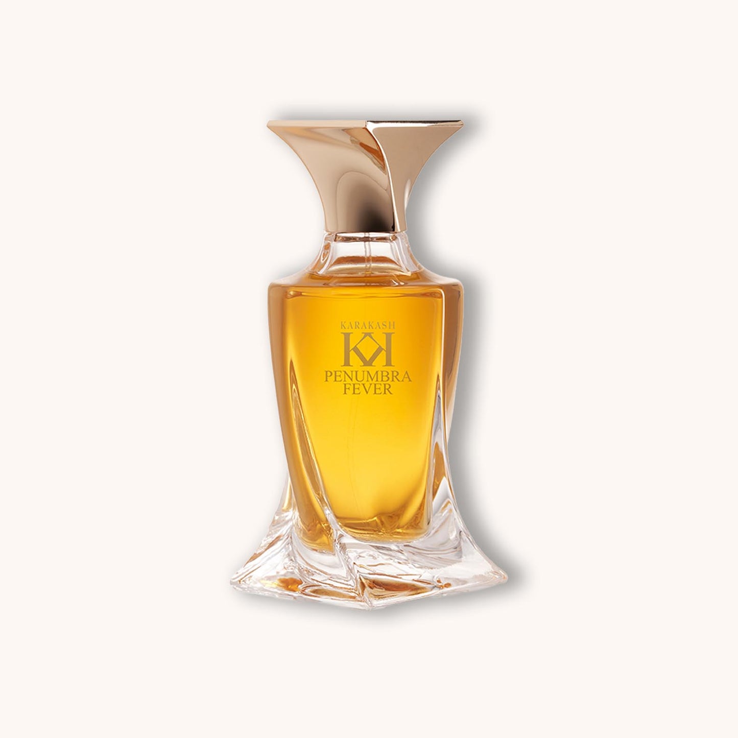 Alt text: A luxurious bottle of Karakash Penumbra Fever fragrance, featuring a distinctive geometric design with a golden liquid inside, radiating elegance and allure.