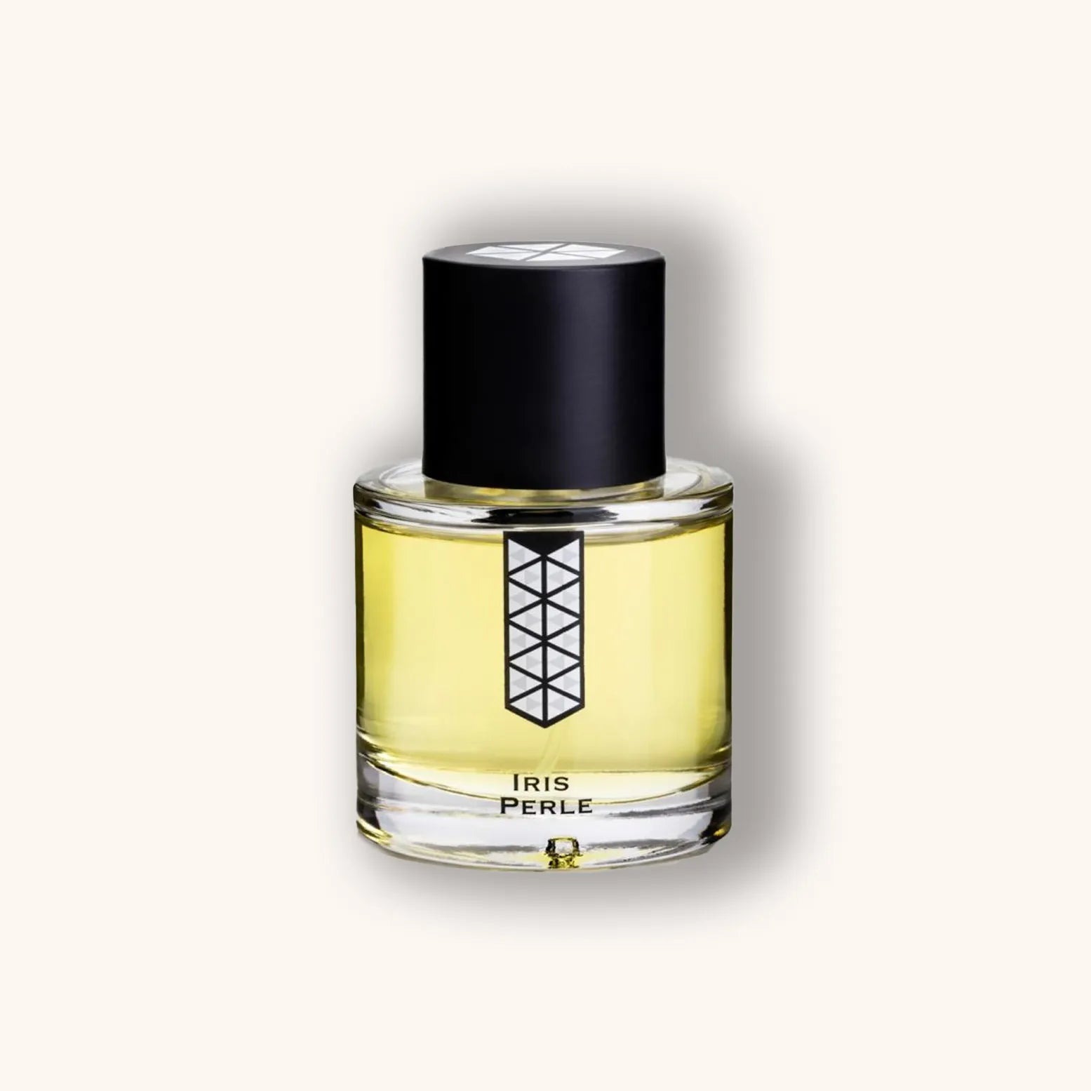 Alt text: Clear glass bottle of 'Les Indémodables Iris Perle' fragrance, featuring a minimalist black cap and a geometric label design, showcasing a pale yellow liquid inside.