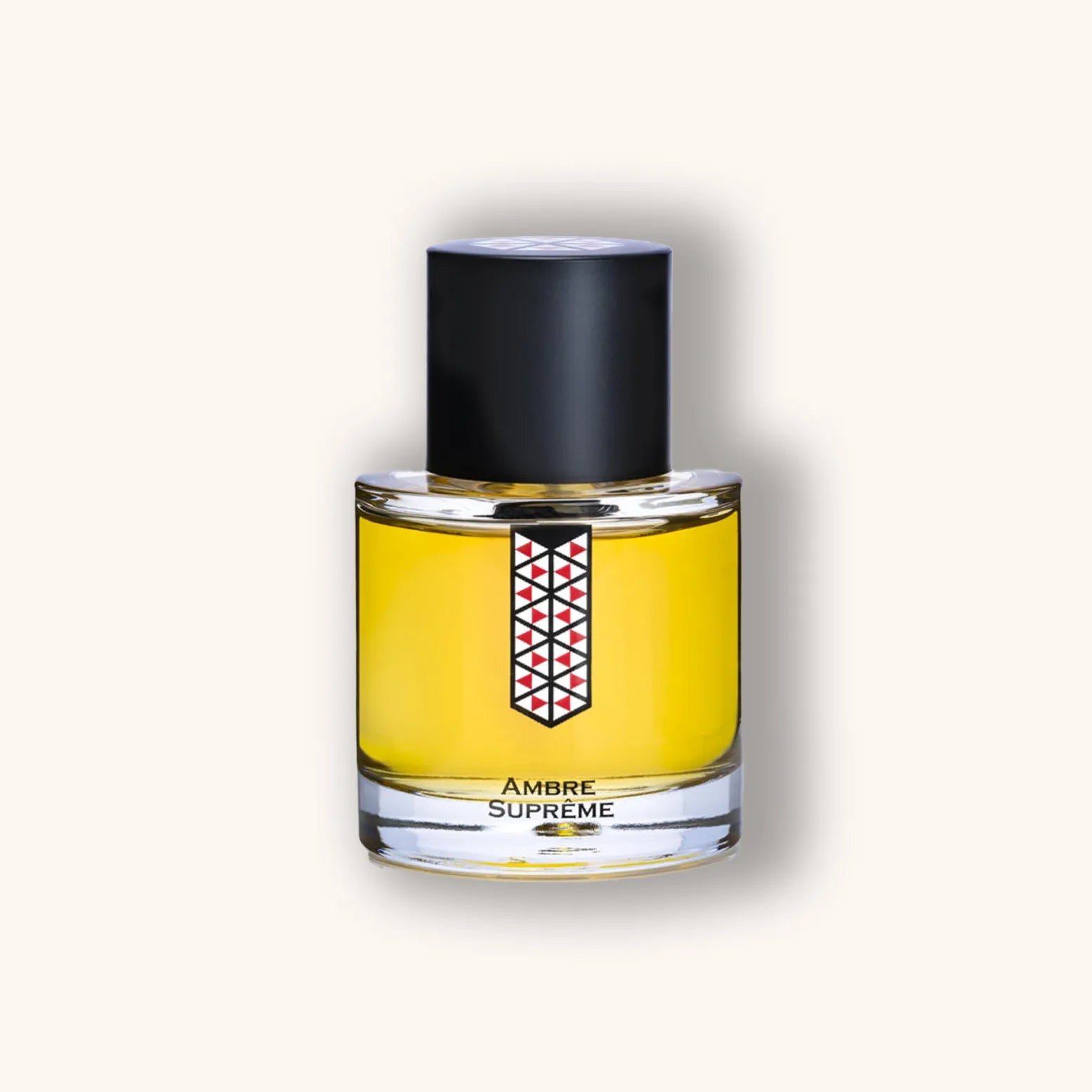 A sleek bottle of Les Indémodables Ambre Suprême perfume, featuring a distinctive geometric design and a rich amber-colored fragrance. The elegant packaging showcases the luxurious essence of the scent.