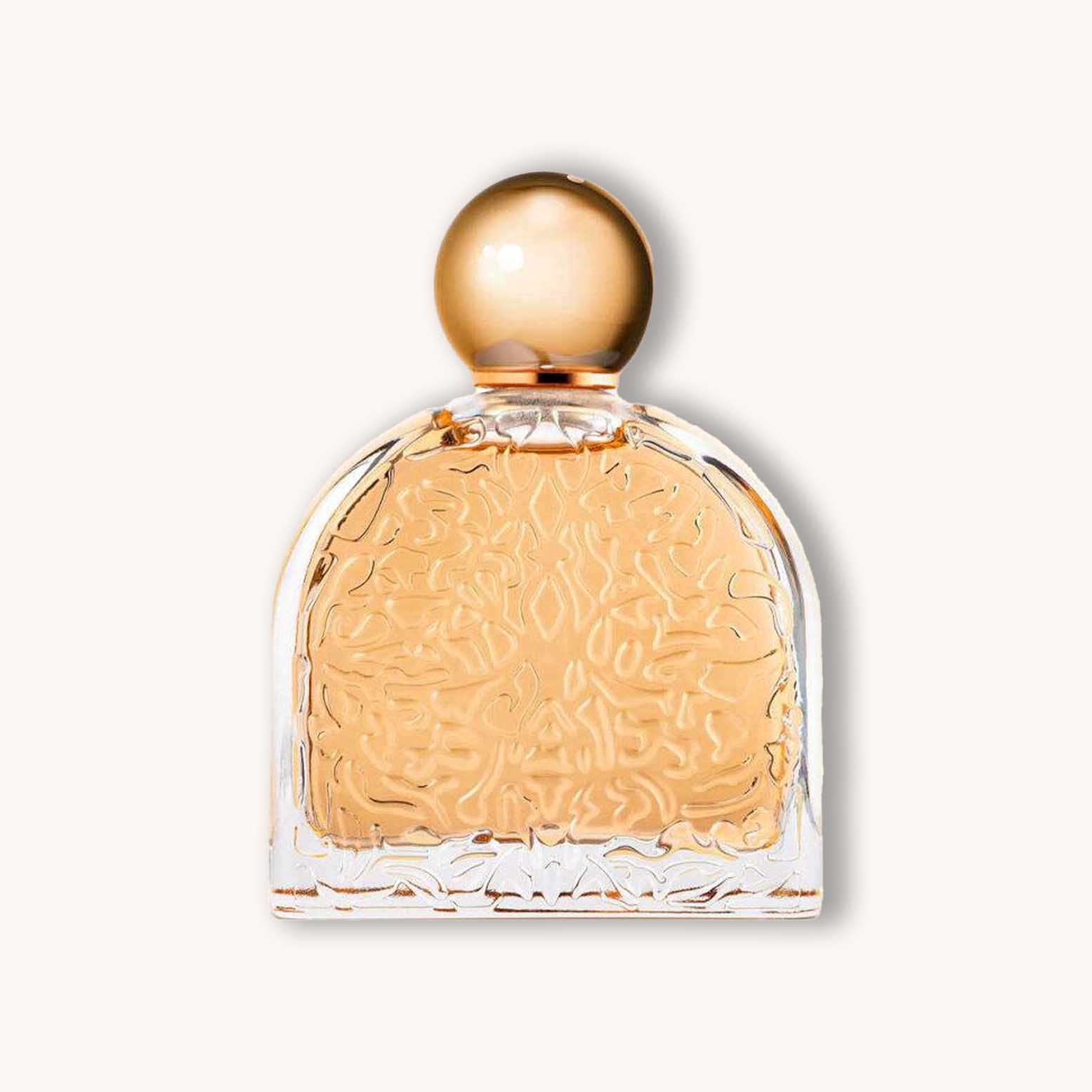 A beautifully designed bottle of M. Micallef Ô Féminin perfume, featuring an ornate glass design and a golden spherical cap, showcasing its elegant fragrance inside.