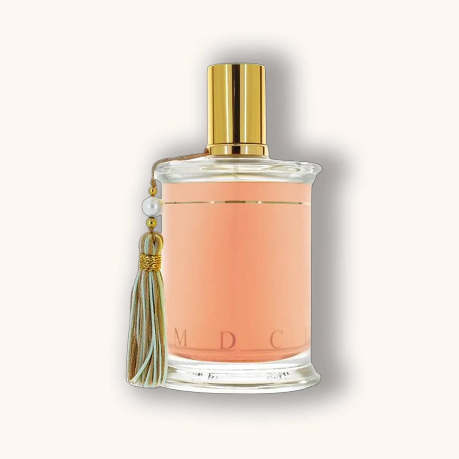 Bottle of MDCI Pêche Cardinal perfume with a peach-hued liquid and pastel green tassel.
