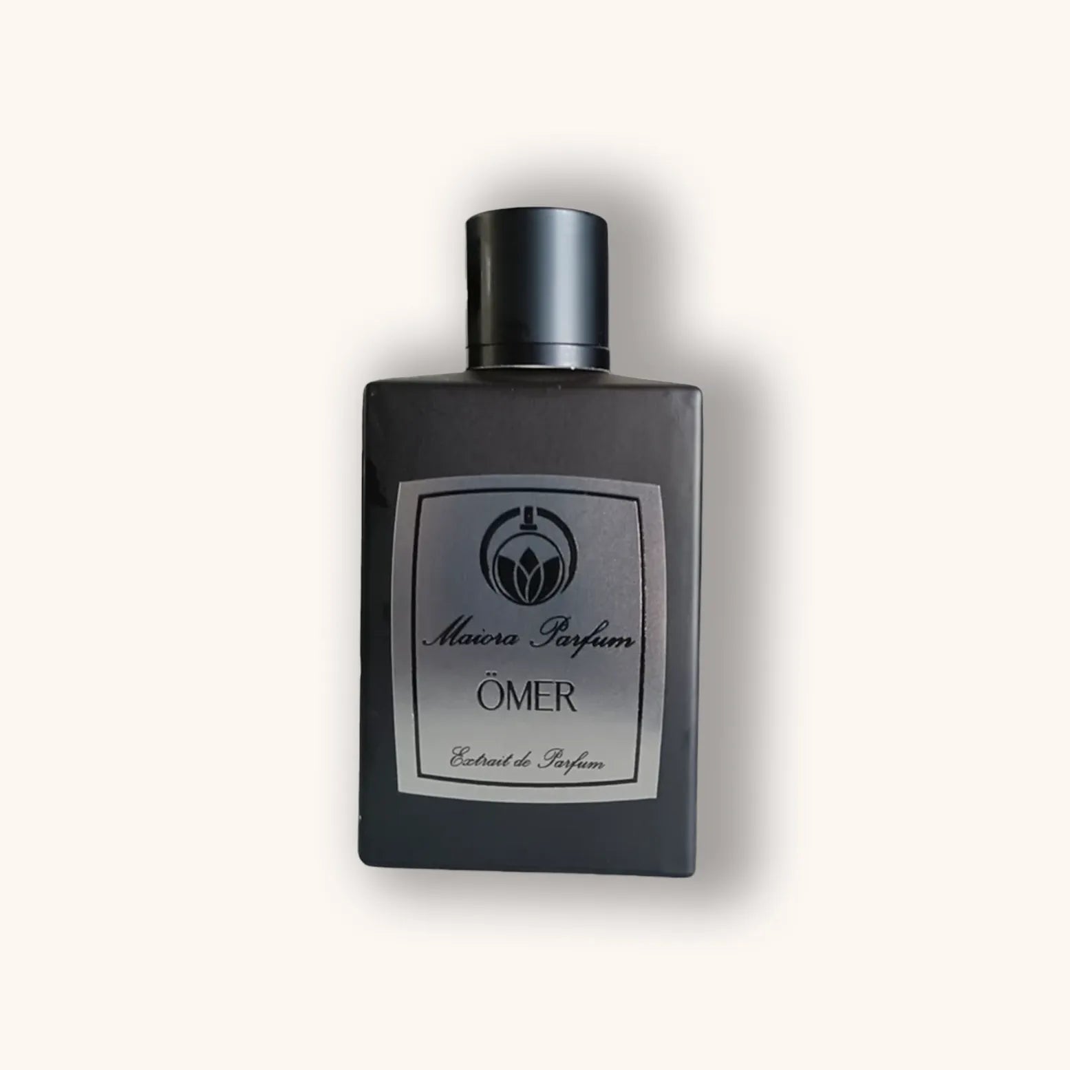 Alt text: A sleek black bottle of Maiora Parfum Ömer, featuring a minimalist design with a silver label that reads "Extrait de Parfum."