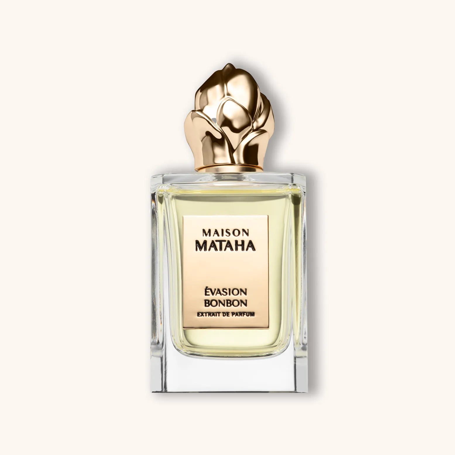 Alt text: A luxurious bottle of Maison Mataha Évasion Bonbon perfume, featuring a golden floral cap and elegantly designed glass packaging, highlighting its rich, sweet fragrance.