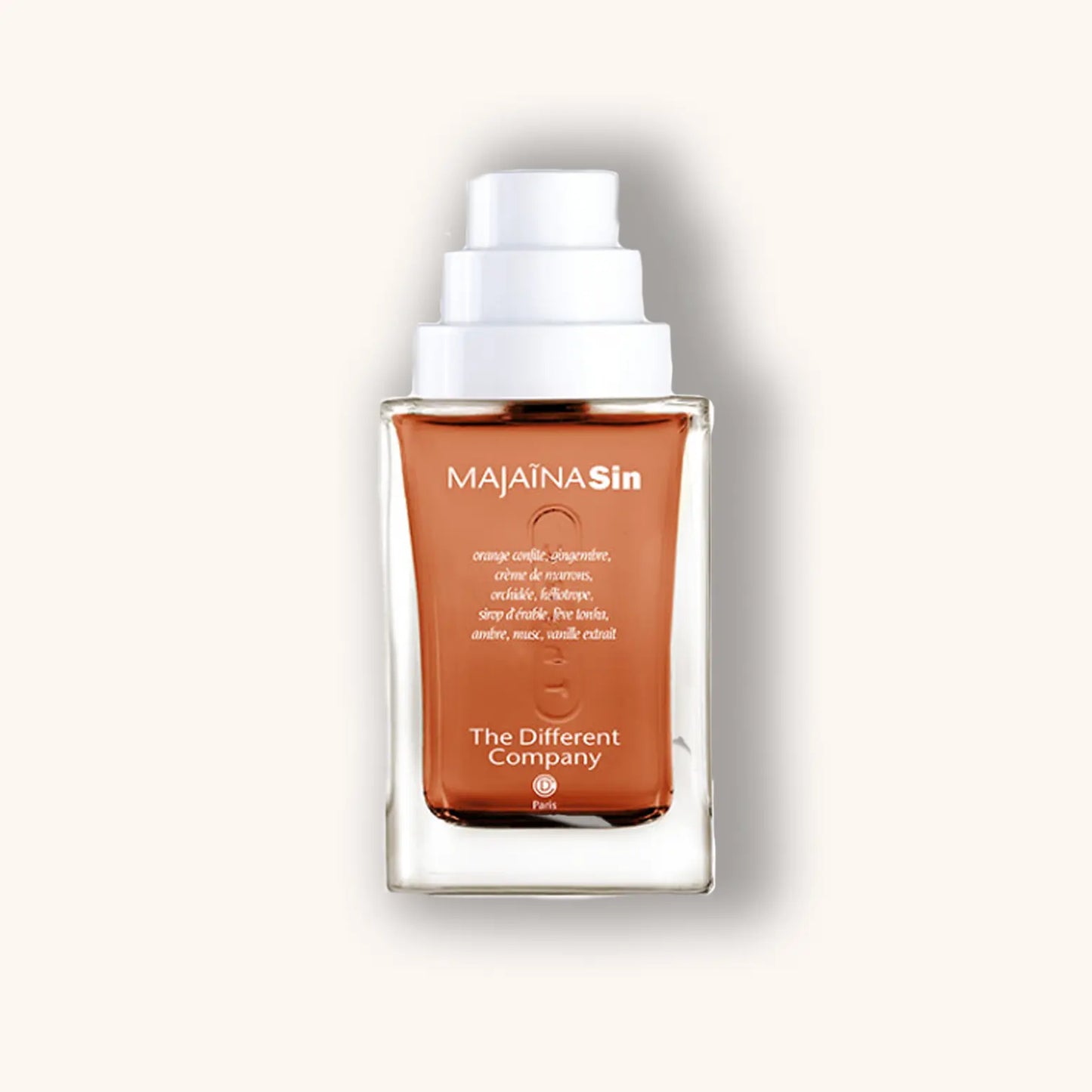 Alt tag: A sleek bottle of 'The Different Company Majaīna Sin' fragrance, showcasing a warm amber liquid housed in an elegant glass container with a pump top. The label features the brand name prominently.
