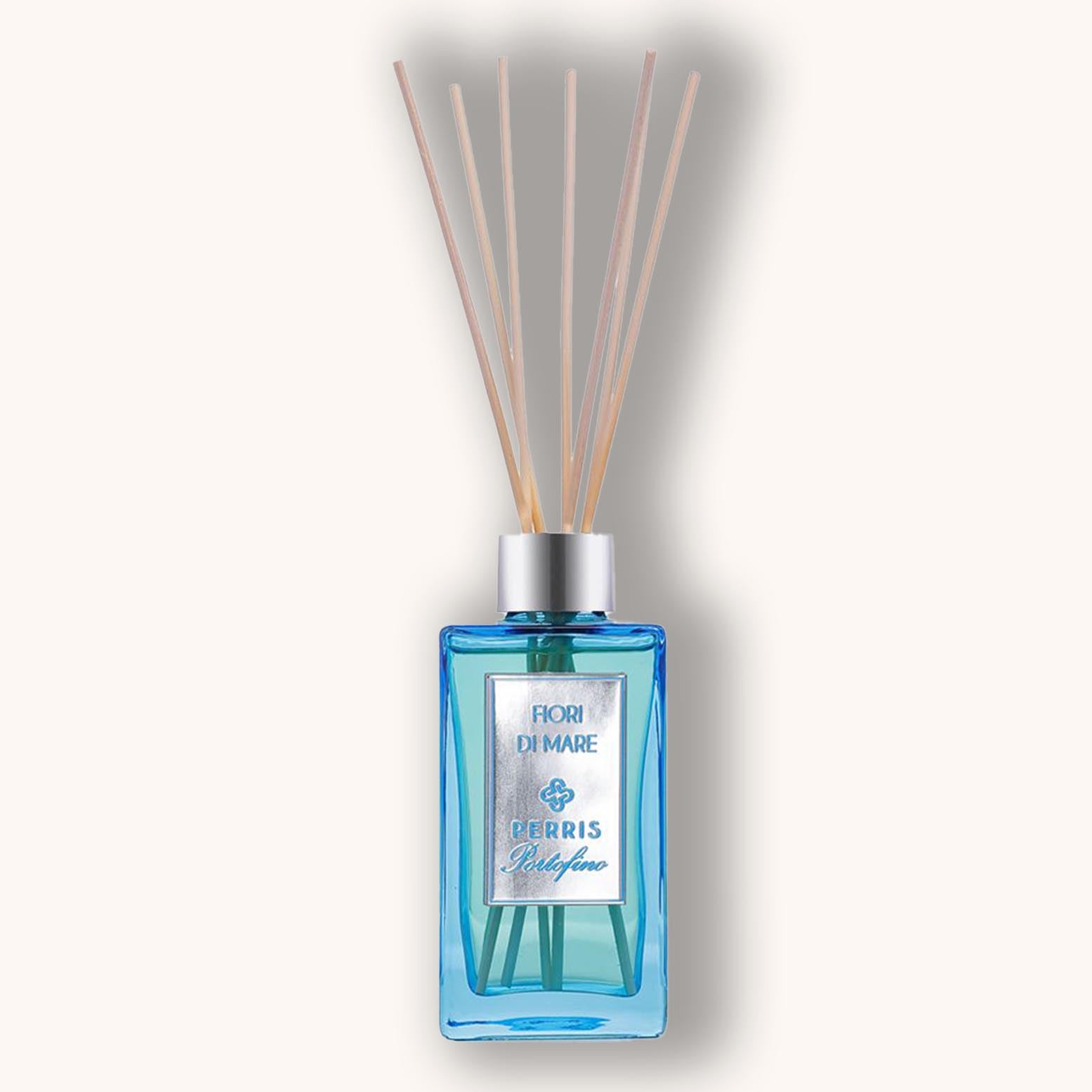 Perris Portofino Fiori di Mare Home Diffuser in a sleek blue glass bottle, featuring a silver cap and aromatic reed sticks for a refreshing fragrance. Ideal for enhancing the ambiance of any space.