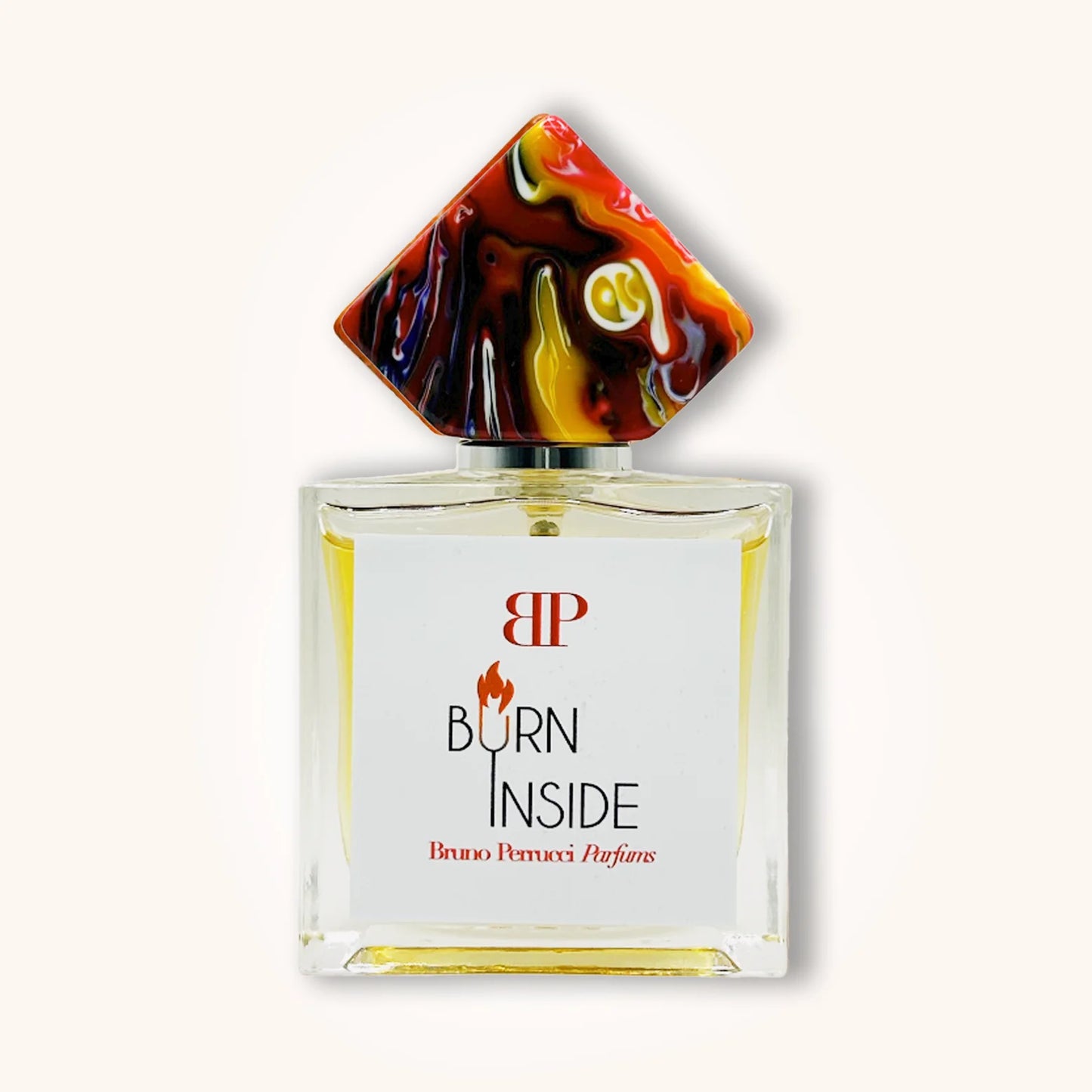 Burn Inside by Bruno Perrucci Parfums in a sleek glass bottle with a fiery red, yellow, and black marbled diamond-shaped cap and minimalist white label.
