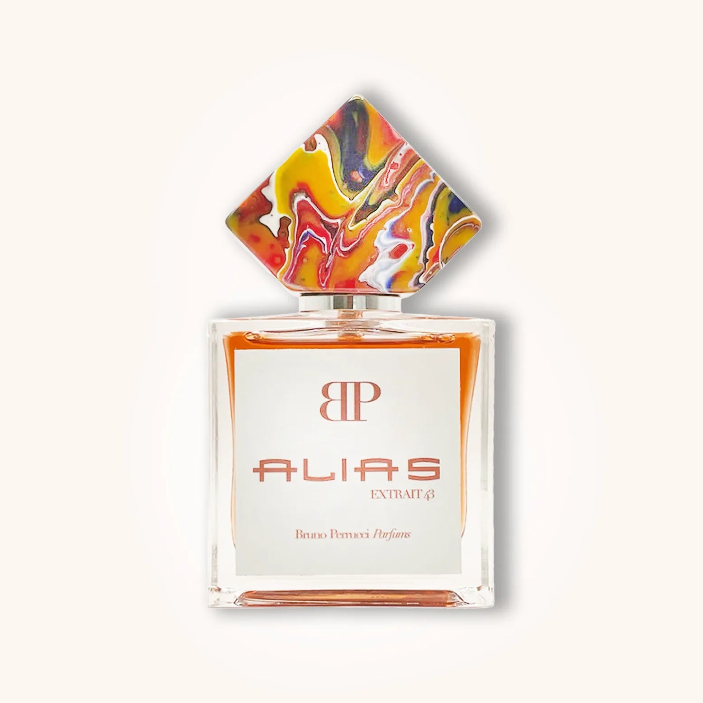 A stylish bottle of 'Bruno Perrucci Alias' perfume, featuring an artistic, multicolored cap and a sleek glass design. The label prominently displays the name "ALIAS" along with the brand initials "BP."