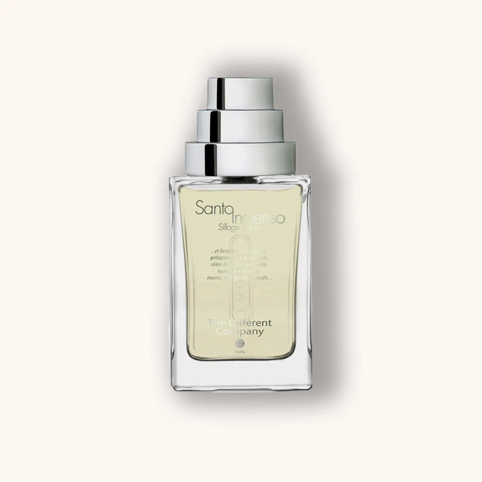 Alt text: A sleek, transparent bottle of "The Different Company Santo Incienso, Sillage Sacré," featuring a minimalist design and a subtle yellow liquid inside, set against a soft beige background.