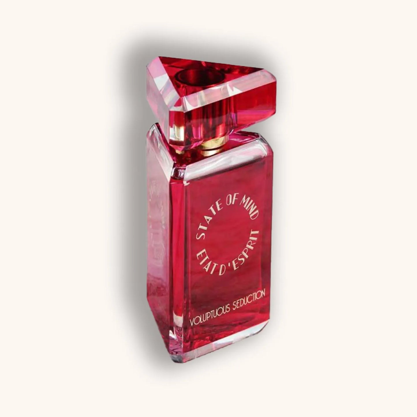 Alt text: A striking red perfume bottle labeled "State of Mind Voluptuous Seduction," featuring a unique triangular cap and elegant design, exuding a sense of allure and sophistication.