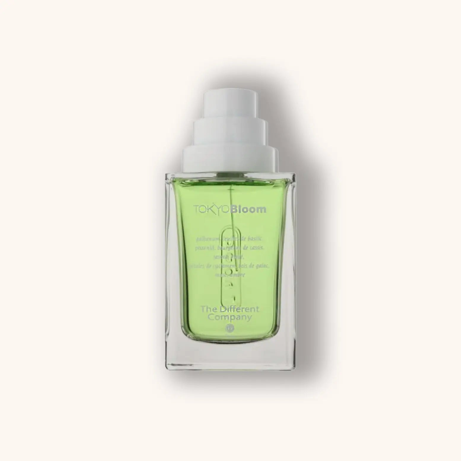 Alt text: A sleek glass bottle of 'The Different Company Tokyo Bloom' featuring a vibrant green liquid inside. The minimalist design emphasizes the product's freshness and elegance.