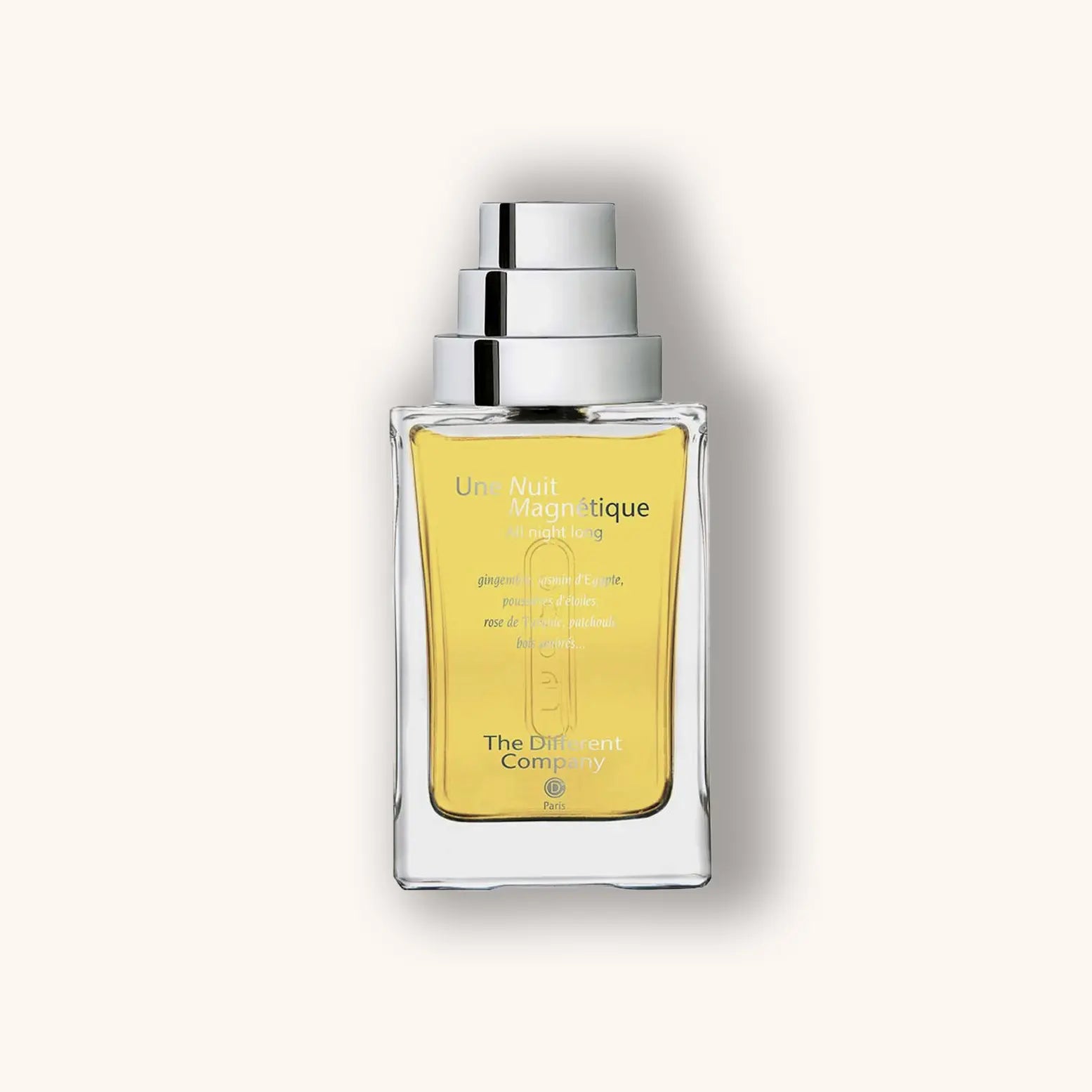 Alt text: A clear glass bottle of "The Different Company Une Nuit Magnétique" perfume, featuring a sleek silver cap and a bright yellow fragrance inside. The design is elegant and minimalistic, reflecting the luxurious essence of the scent.