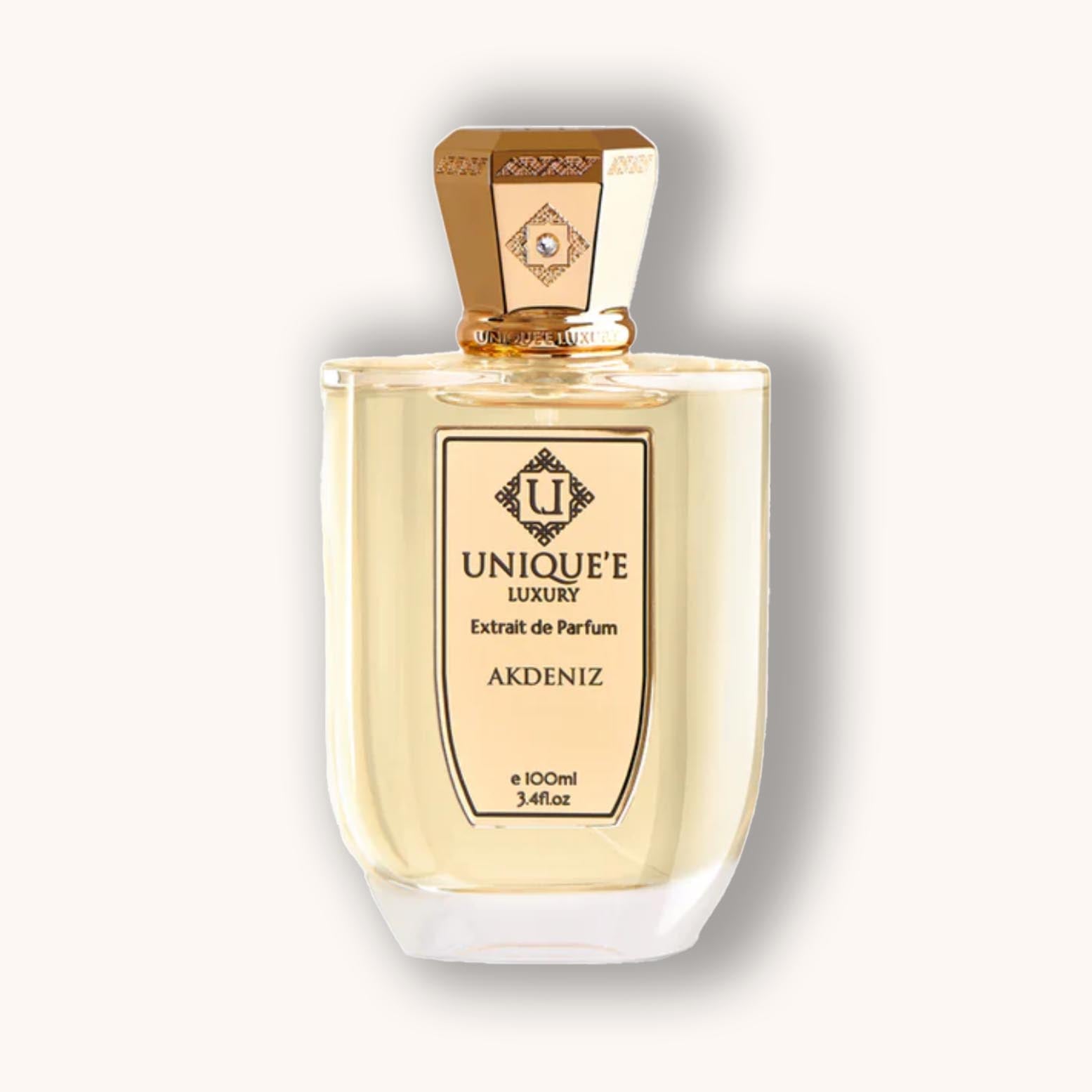 Alt text: A bottle of Unique'e Luxury Akdeniz, a sophisticated extrait de parfum, featuring a sleek design with a golden cap and elegant labeling, encapsulating 100ml of luxurious fragrance.