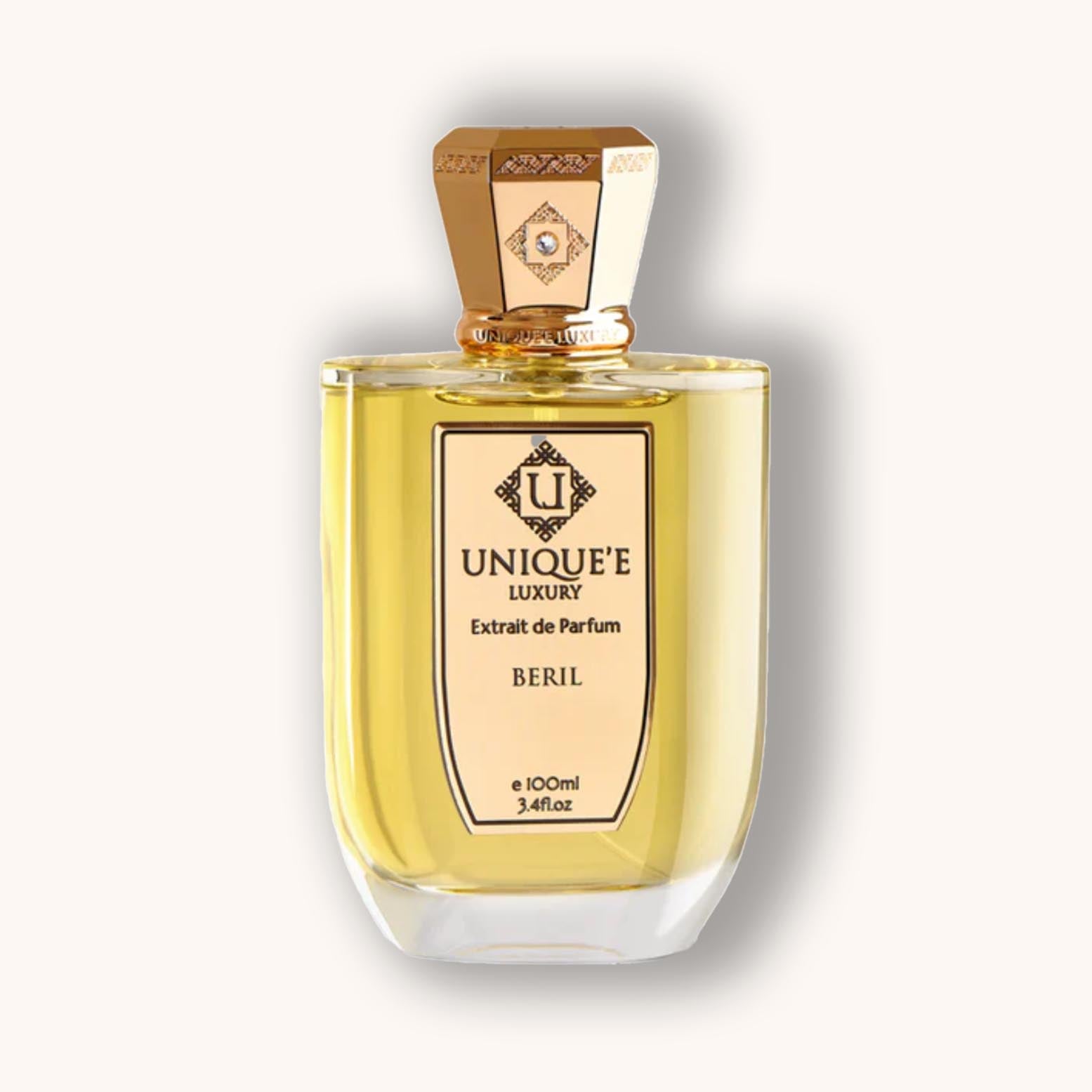 Alt text: A bottle of Unique'e Luxury Beril, featuring a sleek design with a gold cap and a clear glass body, containing 100ml of fragrant perfume. The label highlights its luxurious character.