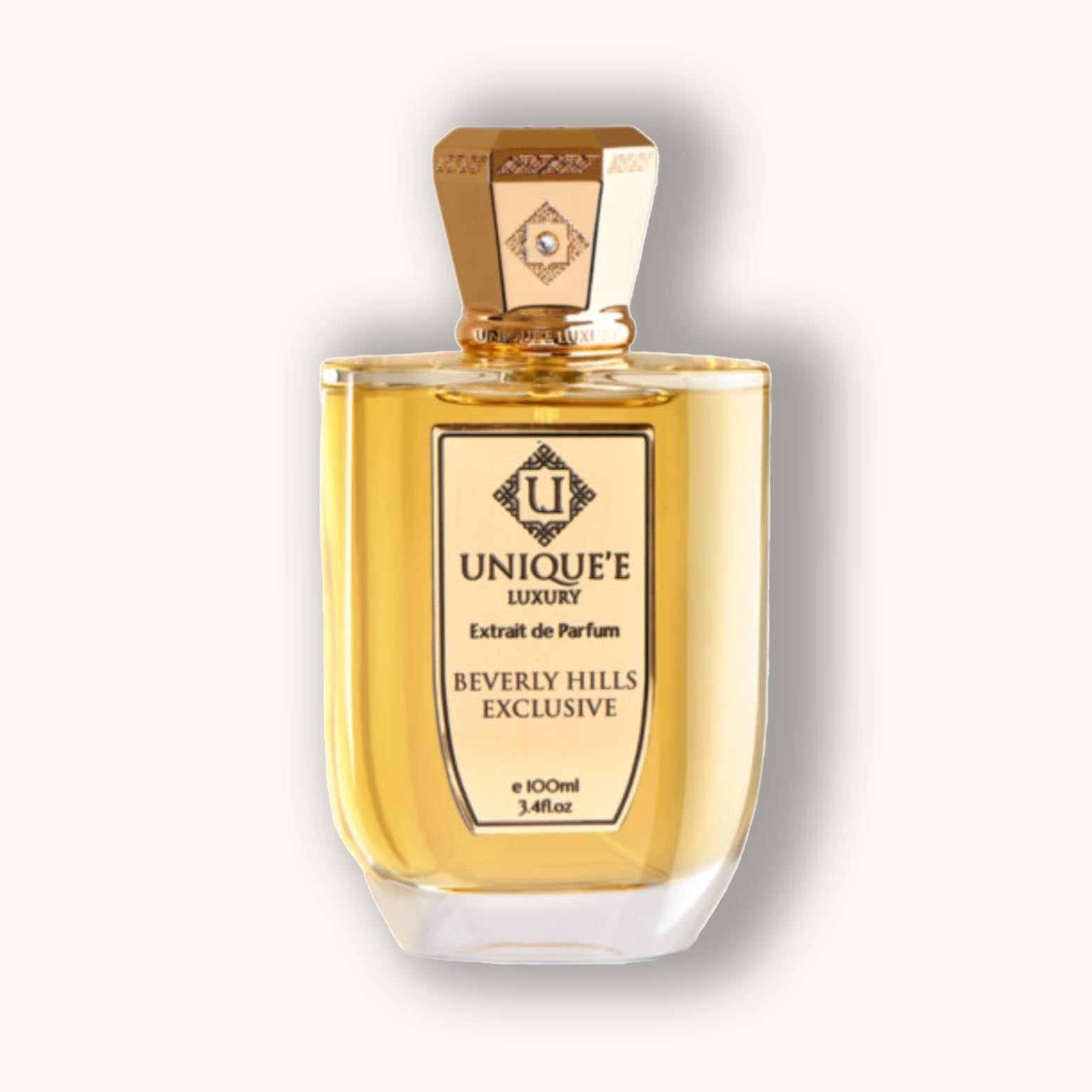 Alt text: A luxurious bottle of Unique'e Luxury Beverly Hills Exclusive perfume, featuring a transparent design with a gold-accented cap and elegant labeling, containing 100ml of exquisite fragrance.