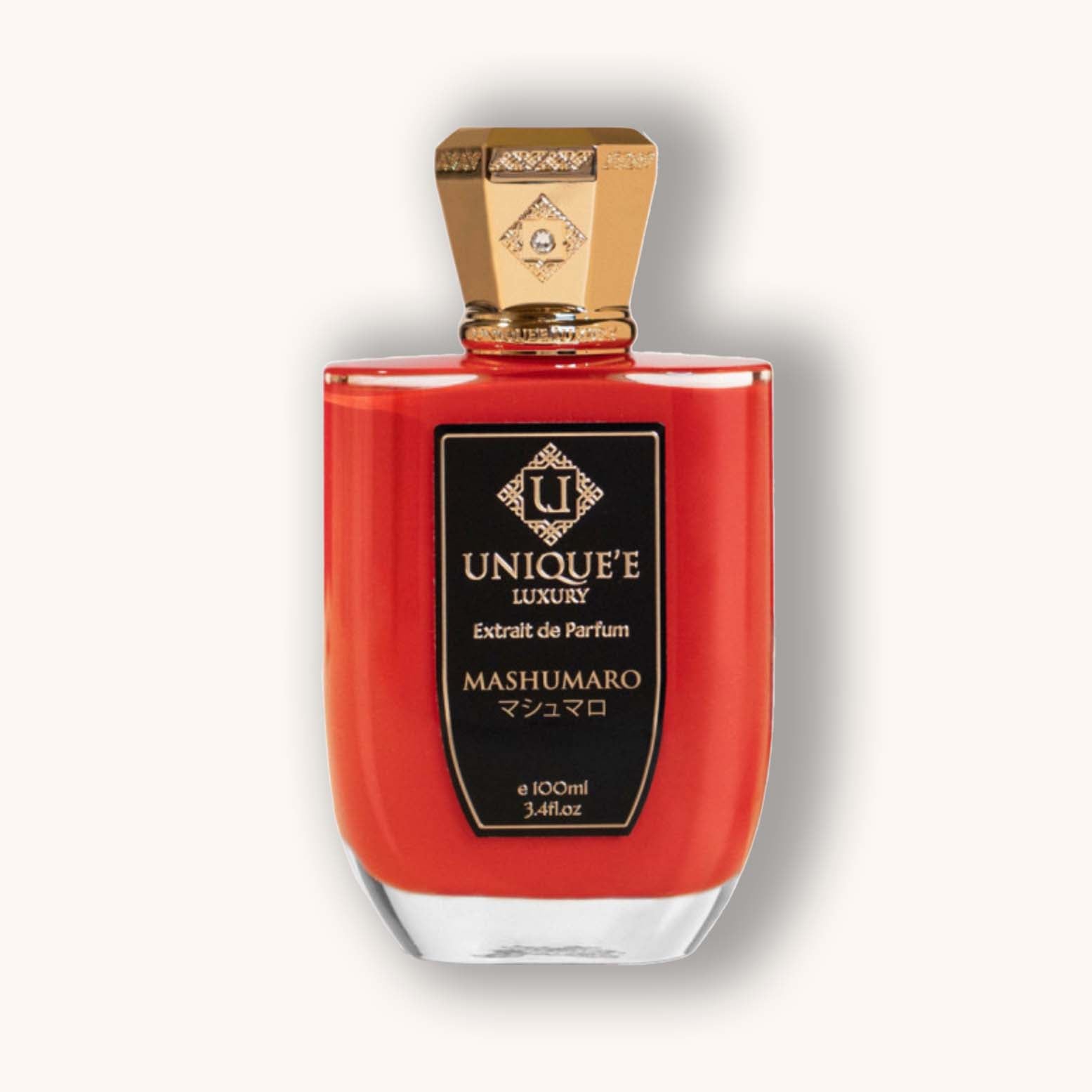 Alt text: A striking red perfume bottle labeled 'Unique'e Luxury Mashumaro,' featuring an elegant gold cap and a sleek design, exuding sophistication and luxury.
