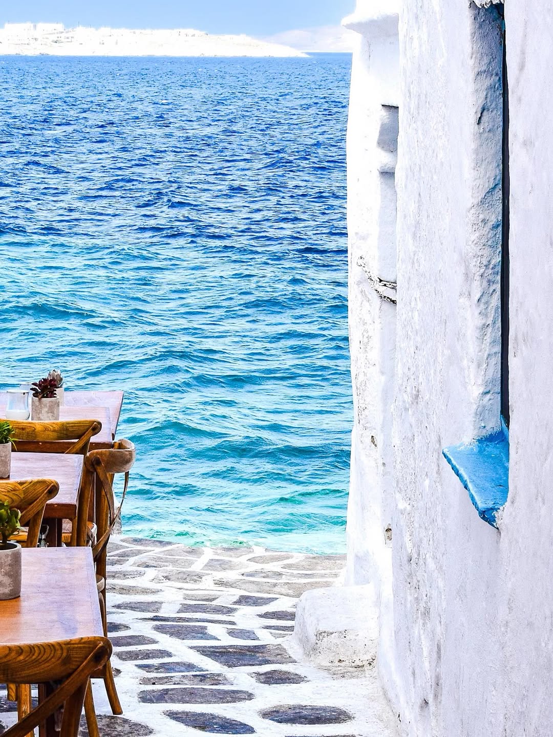 Summer in Greece, white building and blue sea