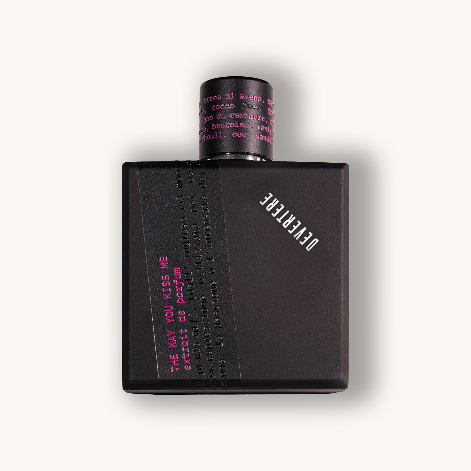 Black perfume bottle of Devertere The Way You Kiss Me with pink text on a white background