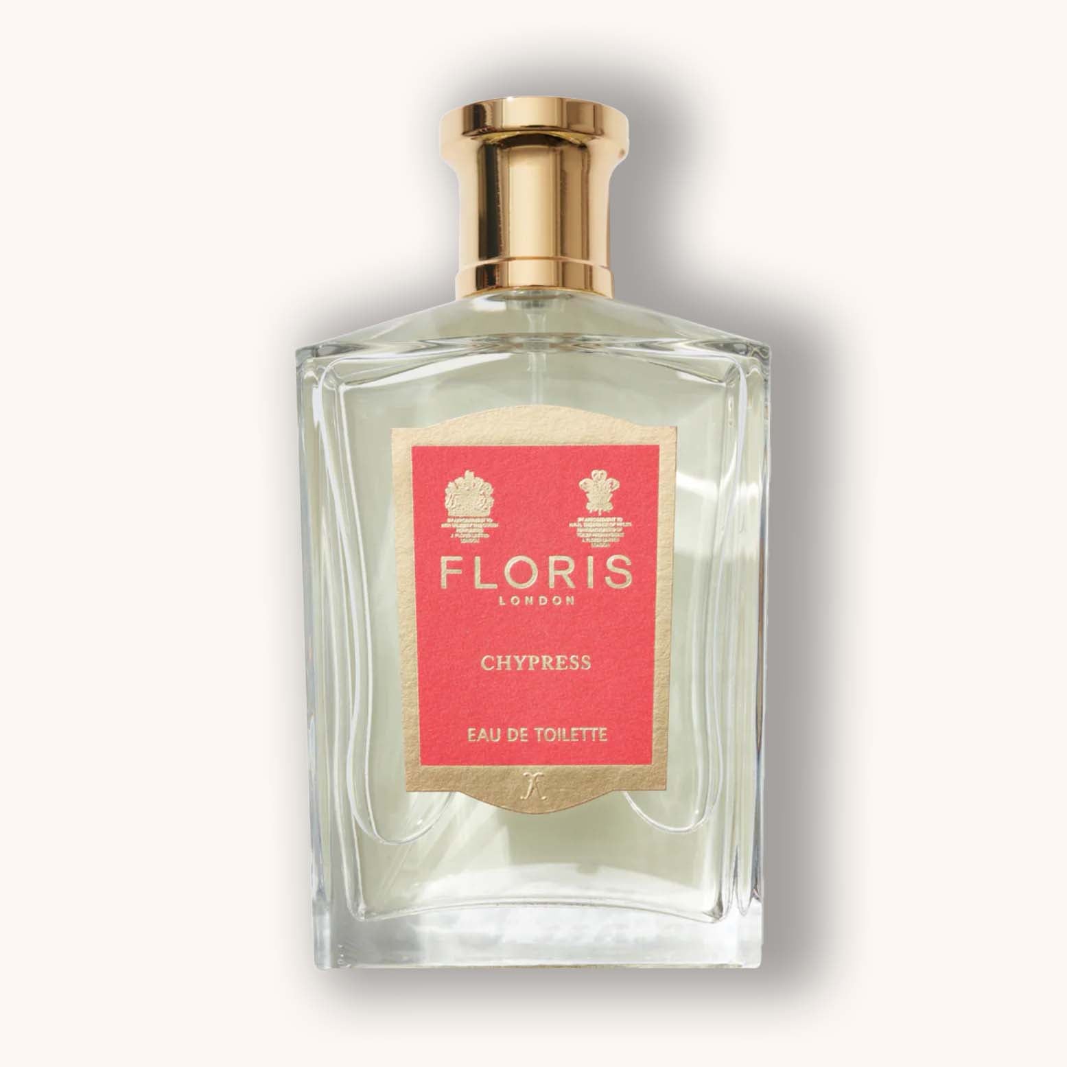 Alt text: A clear glass bottle of Floris London Chypress Eau de Toilette, featuring a gold cap and a distinct coral label with elegant floral accents.