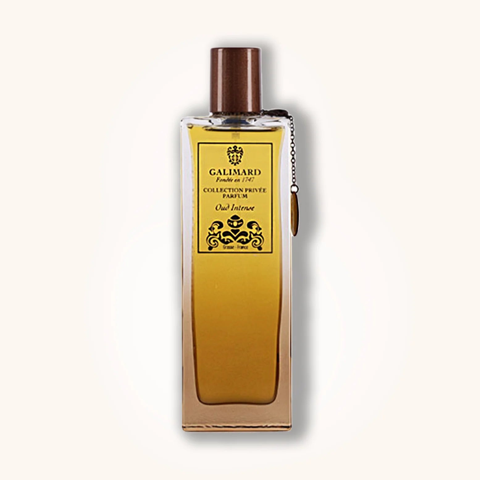Oud Intense by Galimard in a rich golden-yellow bottle with brown cap and high-end black and gold label.