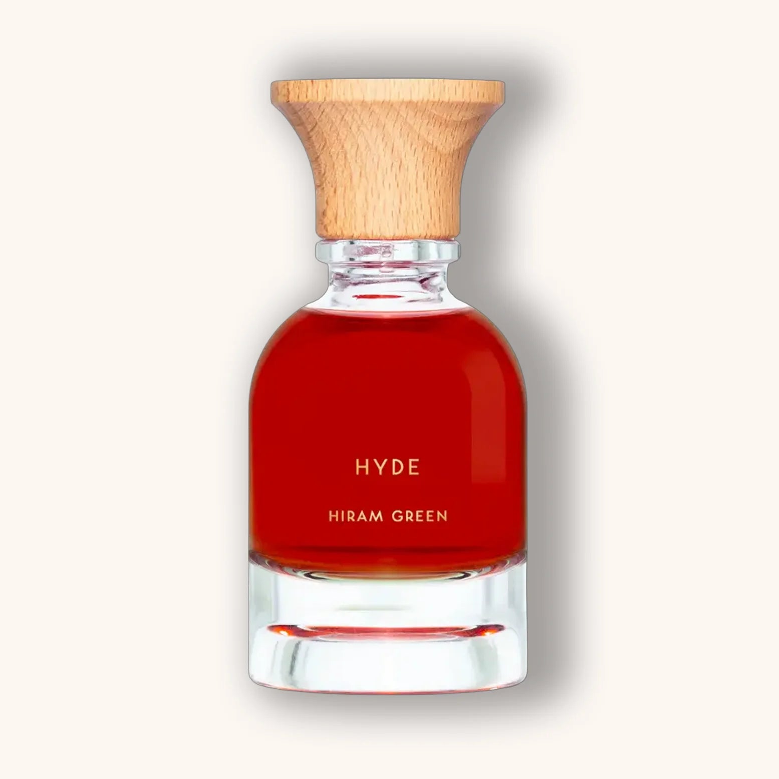 Hiram Green Hyde fragrance in a deep red natural perfume bottle with wooden cap, minimalist style.