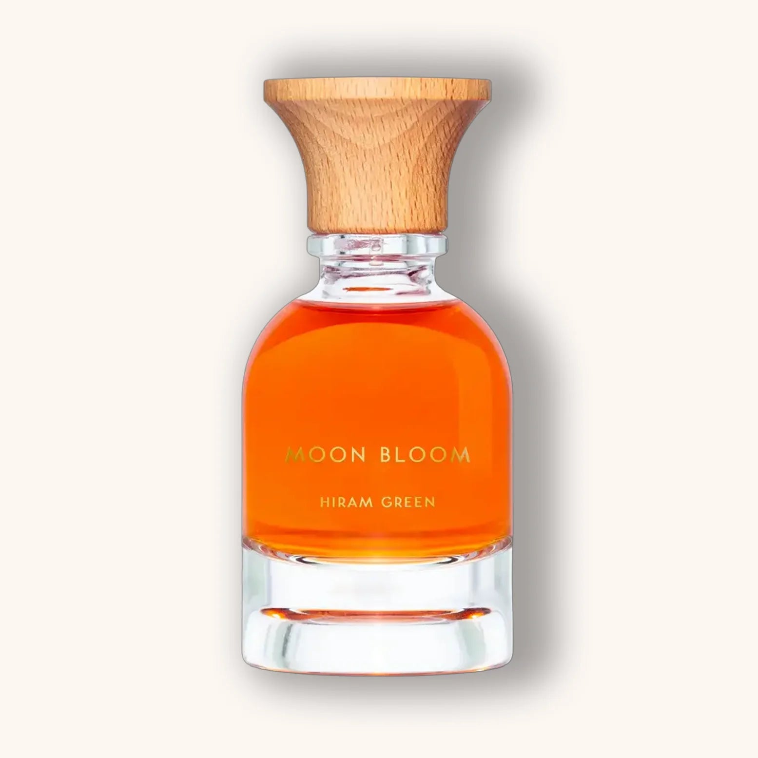 Moon Bloom perfume by Hiram Green with orange liquid and clean design, topped with natural wood cap.