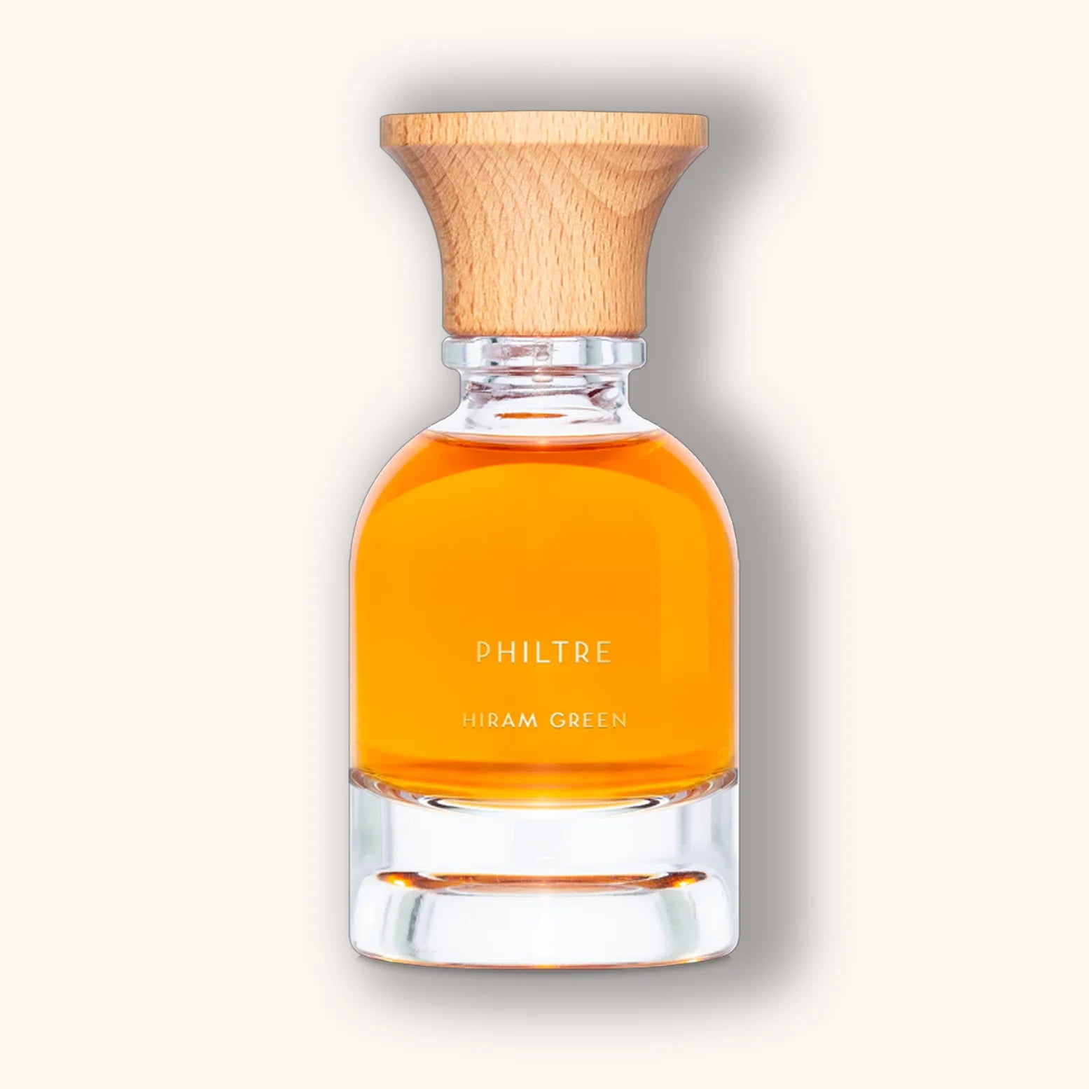 Philtre by Hiram Green shown in a glass bottle with vibrant orange liquid and wooden cap.