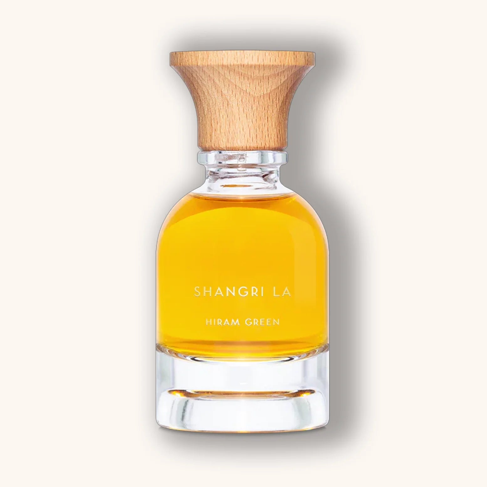 Hiram Green Shangri La perfume bottle with golden-yellow liquid and minimalist wood-topped design.