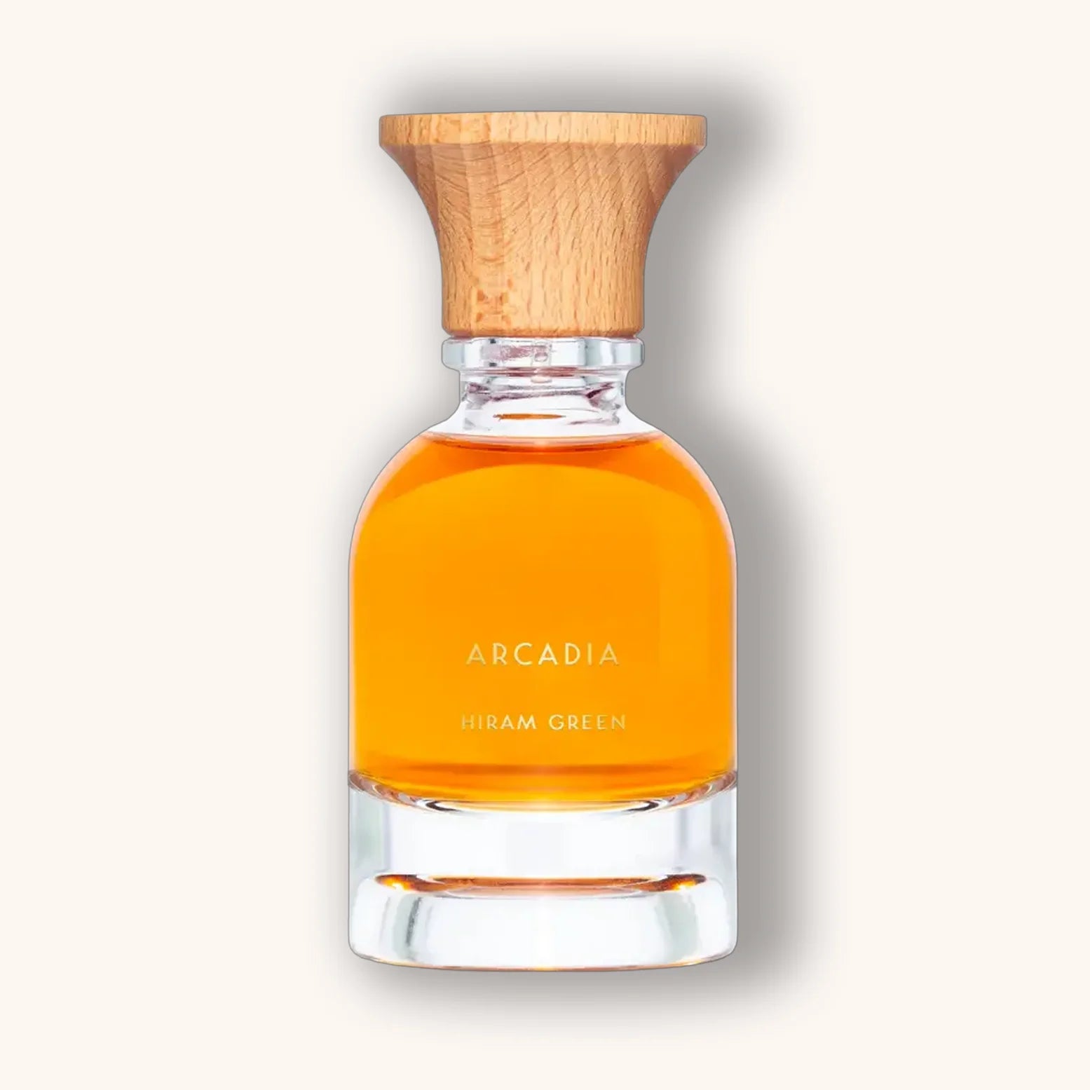 Arcadia natural perfume from Hiram Green in a warm orange tone with wood-textured cap.