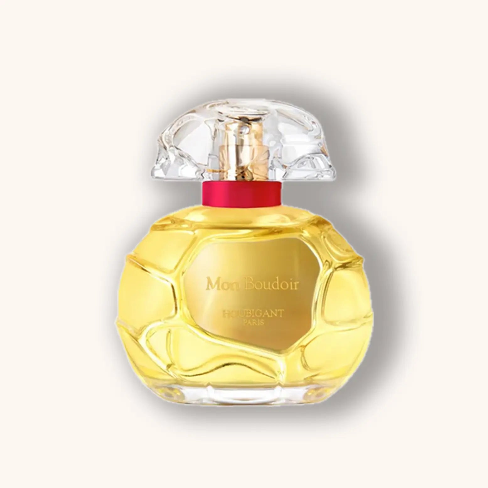 Perfume bottle with a yellow body and clear cap on a light gray background