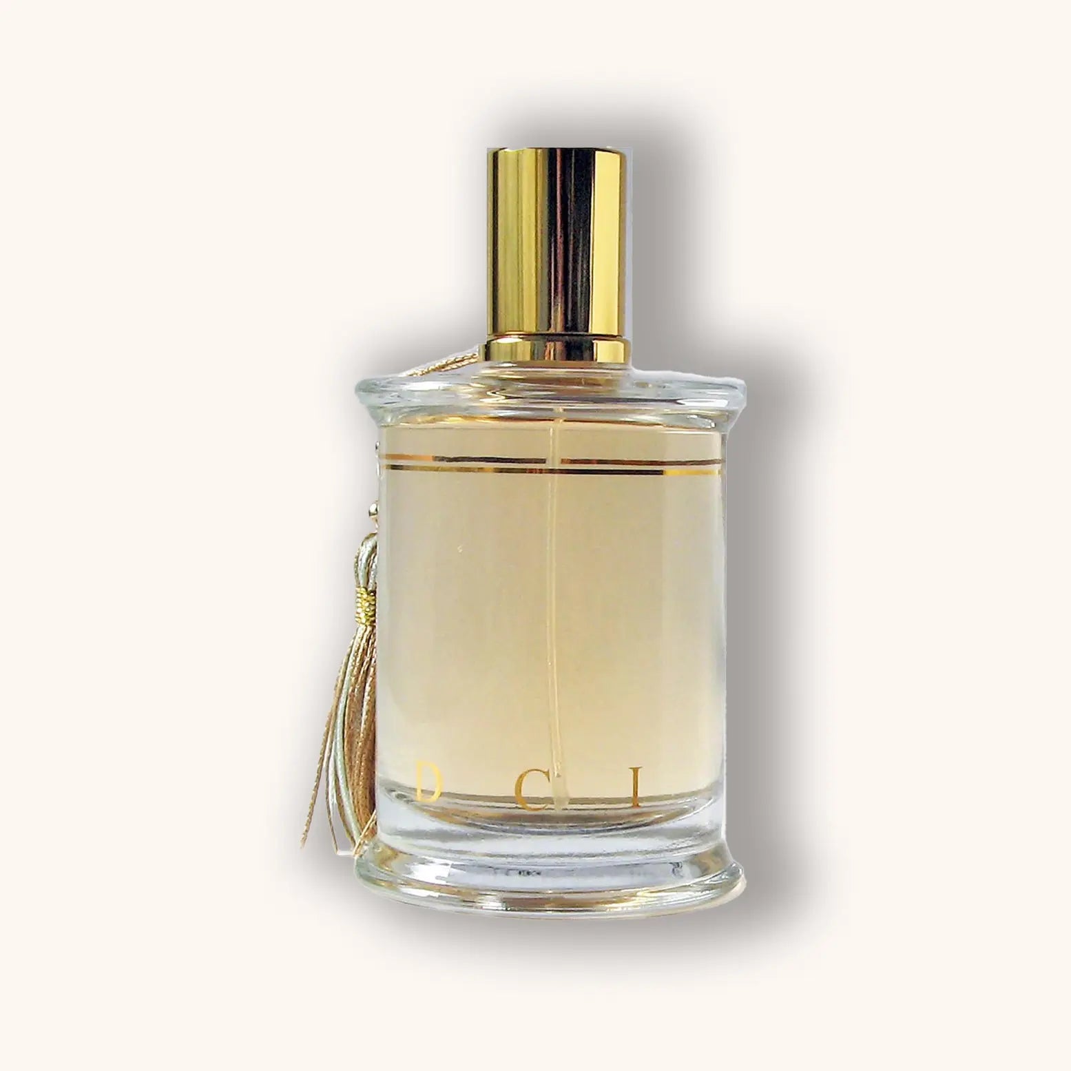Bottle of MDCI Nuit Andalouse perfume with a pale golden liquid and ivory tassel.