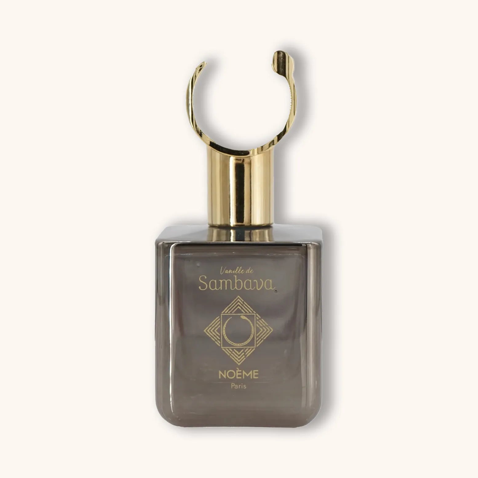 Alt text: A sleek glass perfume bottle with a gold cap, labeled 'Noème Paris Vanille de Sambava'. The bottle features an elegant geometric design and a muted gray tint.