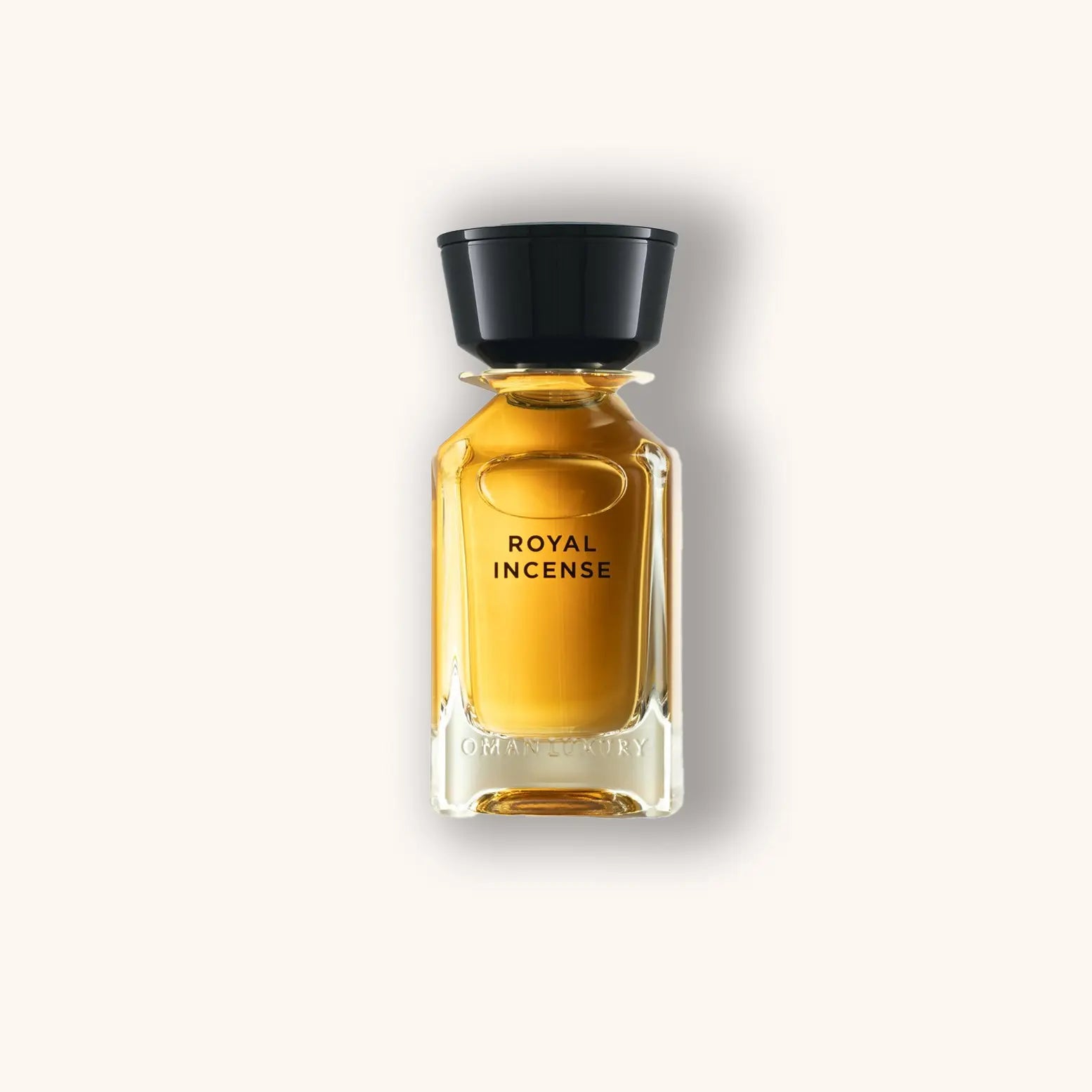 A sleek glass bottle of Omanluxury Royal Incense, featuring a golden liquid and a black cap, elegantly labeled with "Royal Incense." This luxurious fragrance captures the essence of opulence and tradition.