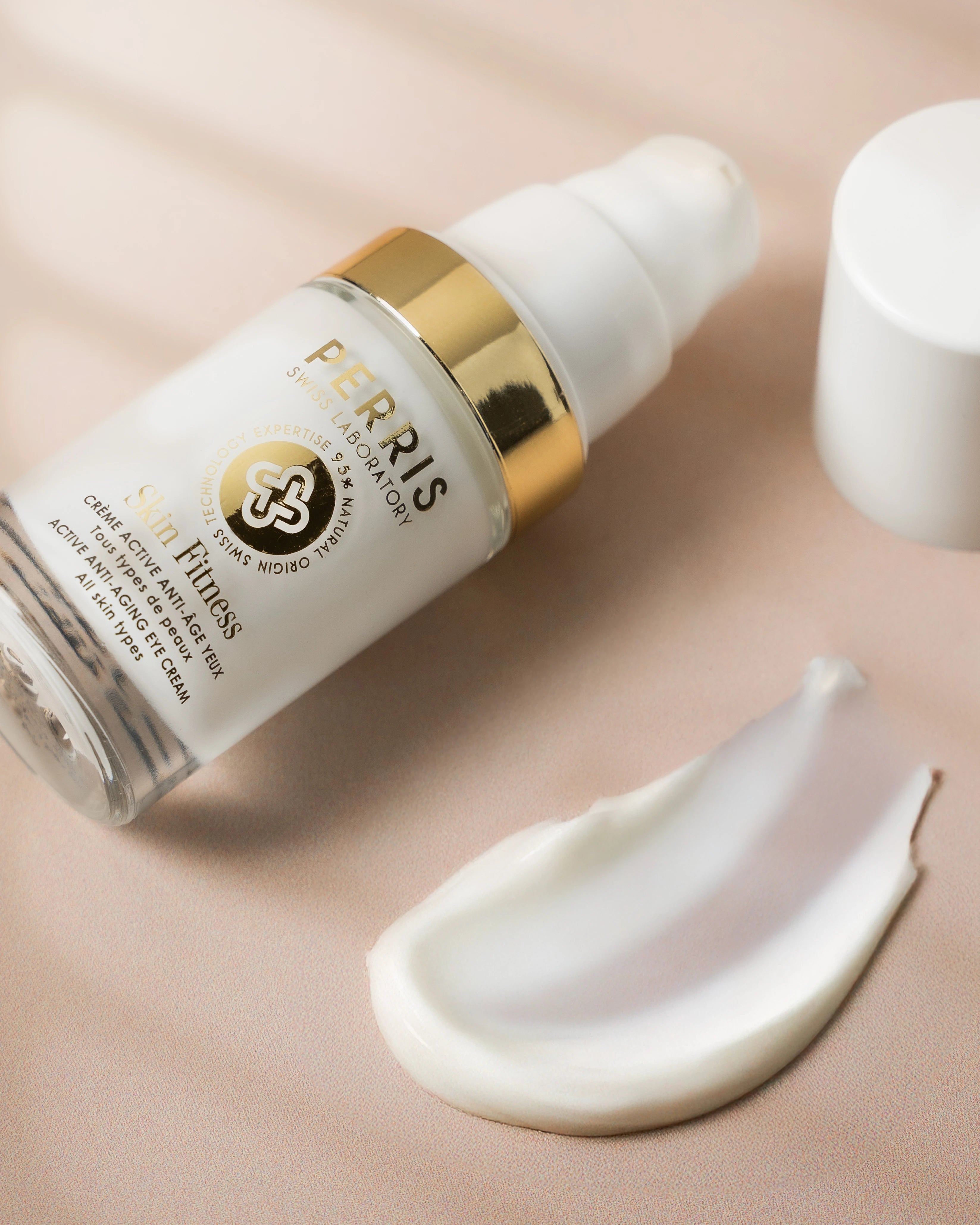 Skincare dropper bottle with applicator on a beige background