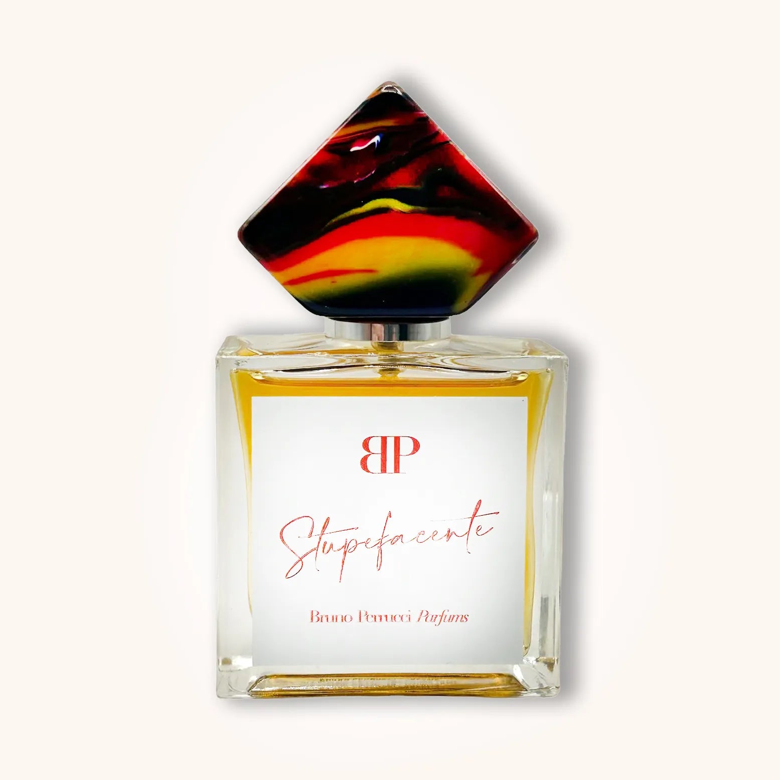 A luxurious perfume bottle of 'Bruno Perrucci Stupefacente', featuring a rectangular glass design with a striking red, yellow, and black geometric cap, adorned with elegant gold lettering.