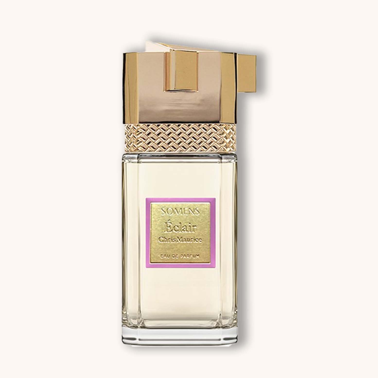 A sleek and elegant bottle of Somens Éclair eau de parfum, featuring a golden cap and a textured metallic band around the neck, set against a soft background. The label prominently displays the name "Somens Éclair" in a sophisticated font.