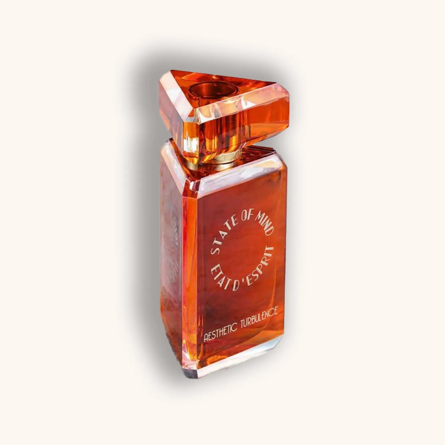 Alt text: A luxurious perfume bottle named "State of Mind Aesthetic Turbulence," featuring a striking triangular top and an amber-hued glass design, elegantly showcasing its unique fragrance.