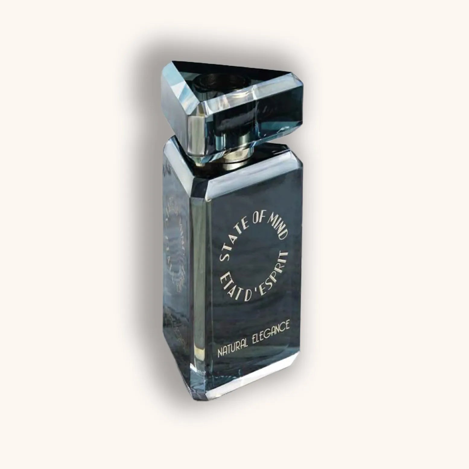 Alt text: A sleek perfume bottle featuring a modern geometric design, labeled "State of Mind Natural Elegance," reflecting a sophisticated elegance with its polished glass surface.